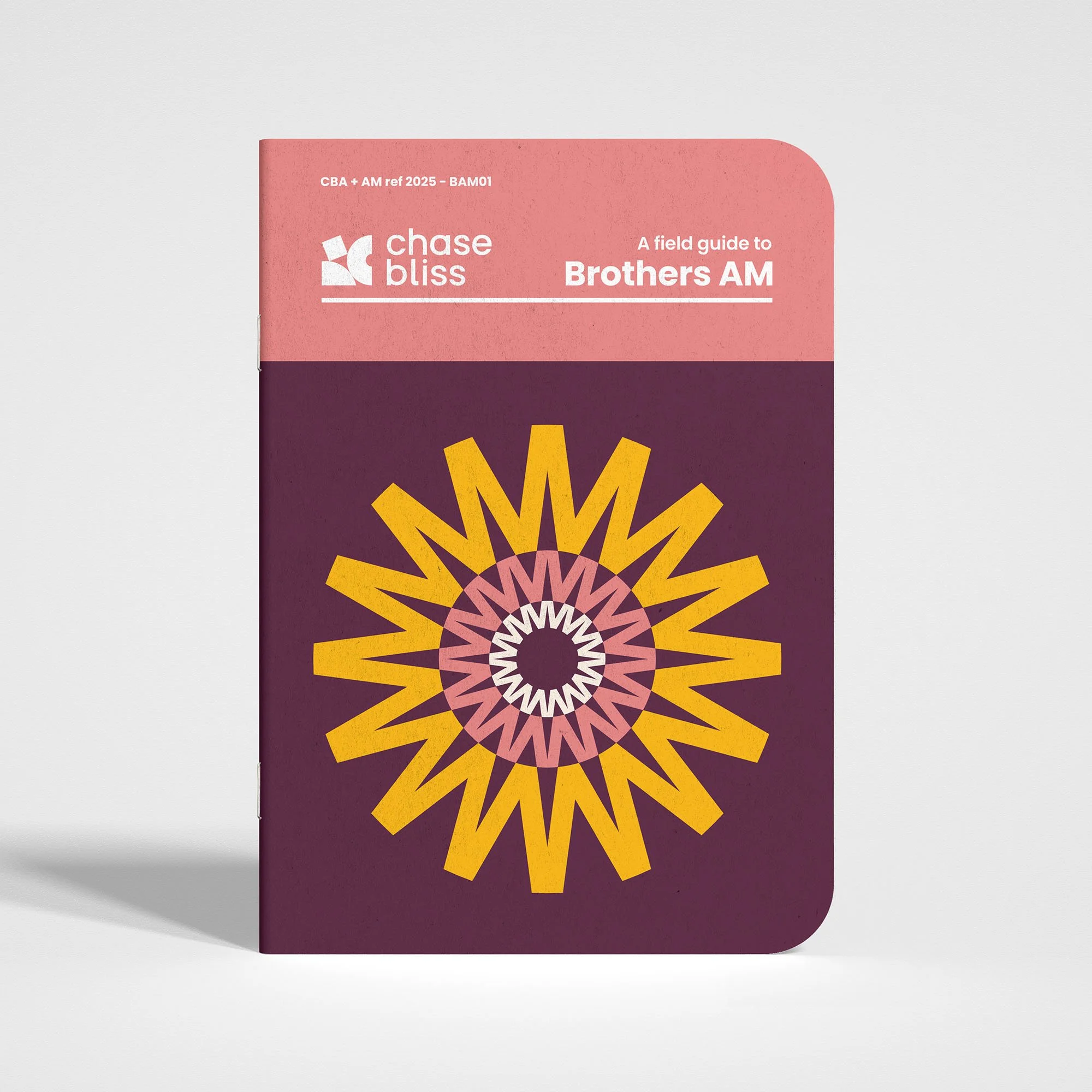 A field guide book titled 'Chase Bliss' with a pink and purple cover featuring a geometric yellow and pink sunburst pattern.