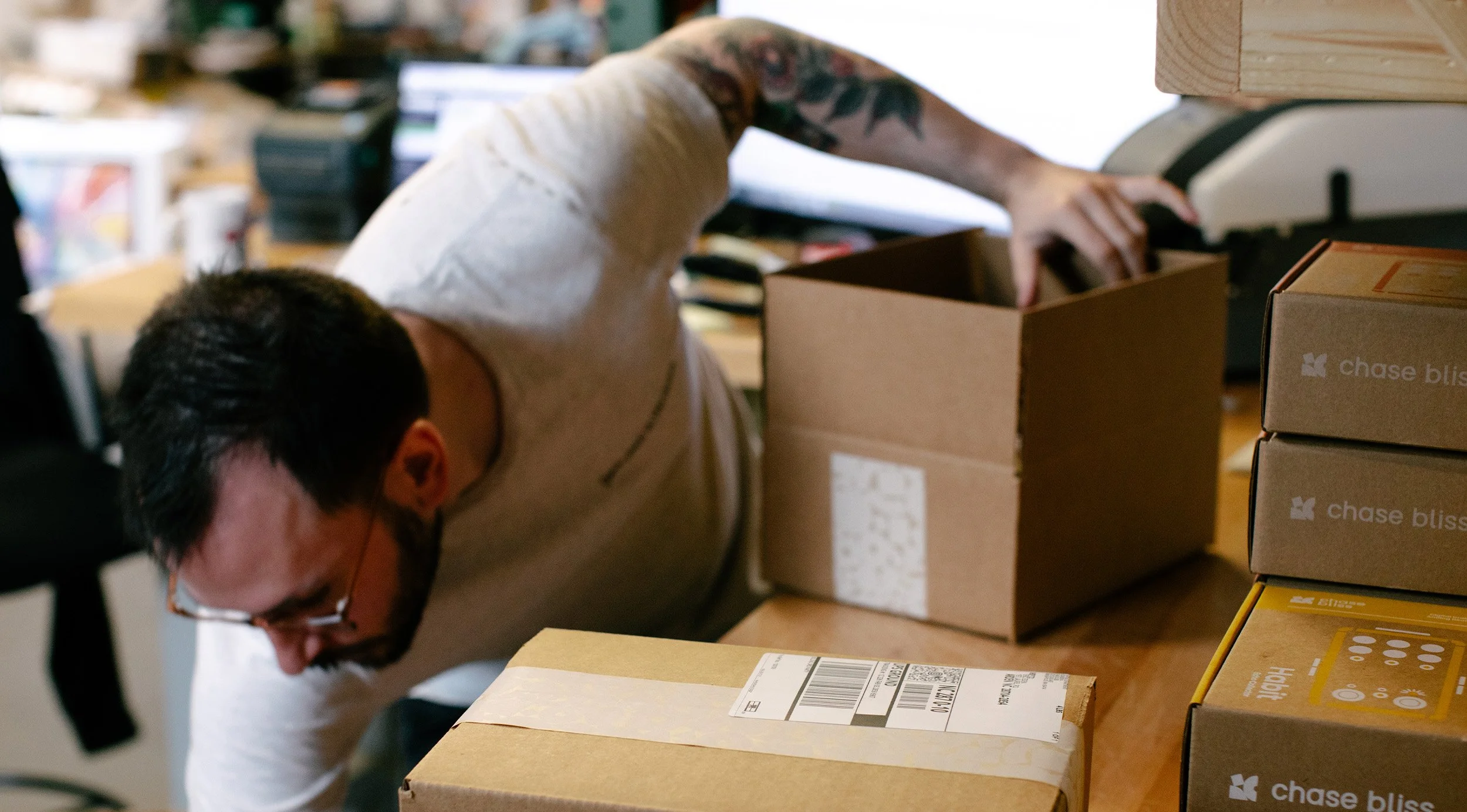 Person packing shipping boxes.