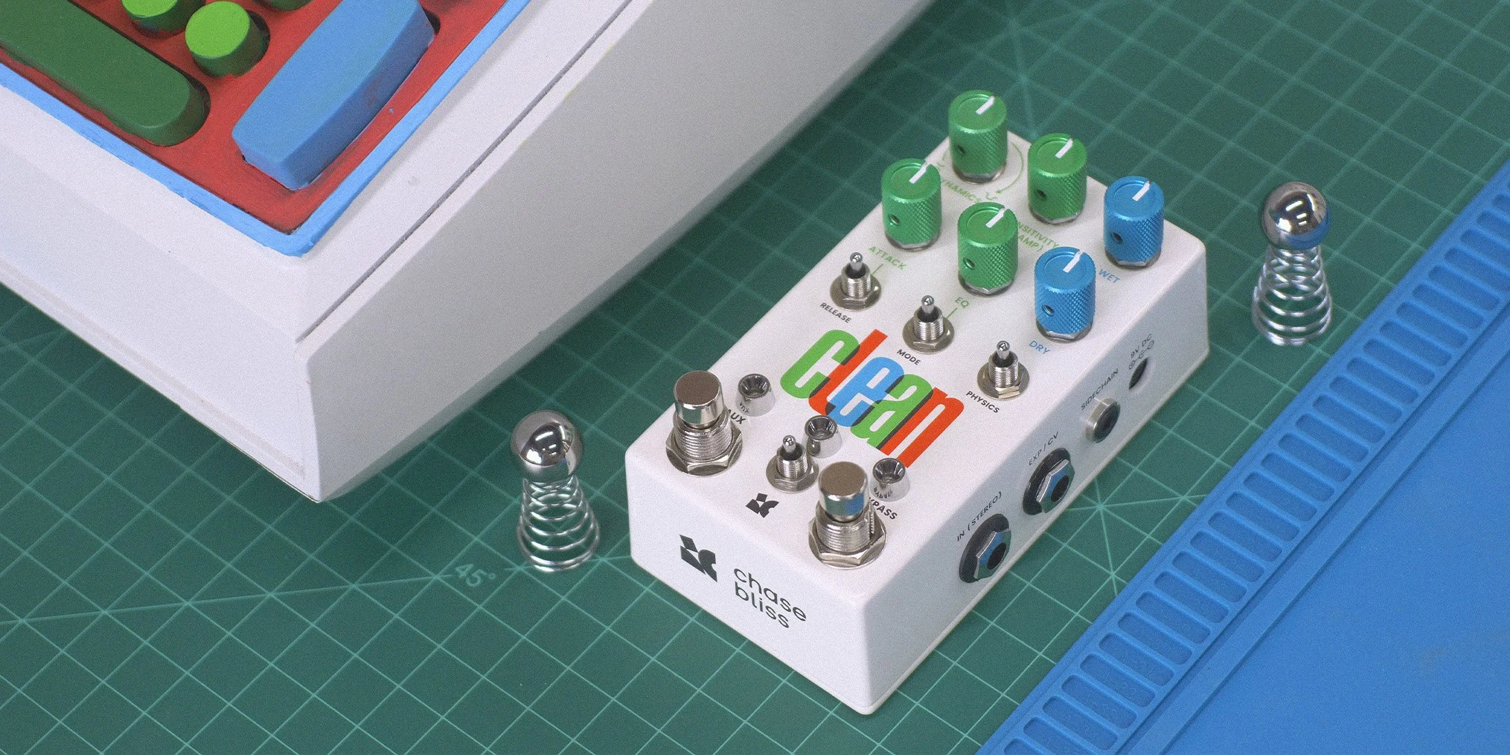 Clean effects pedal placed on retro sci-fi equipment.