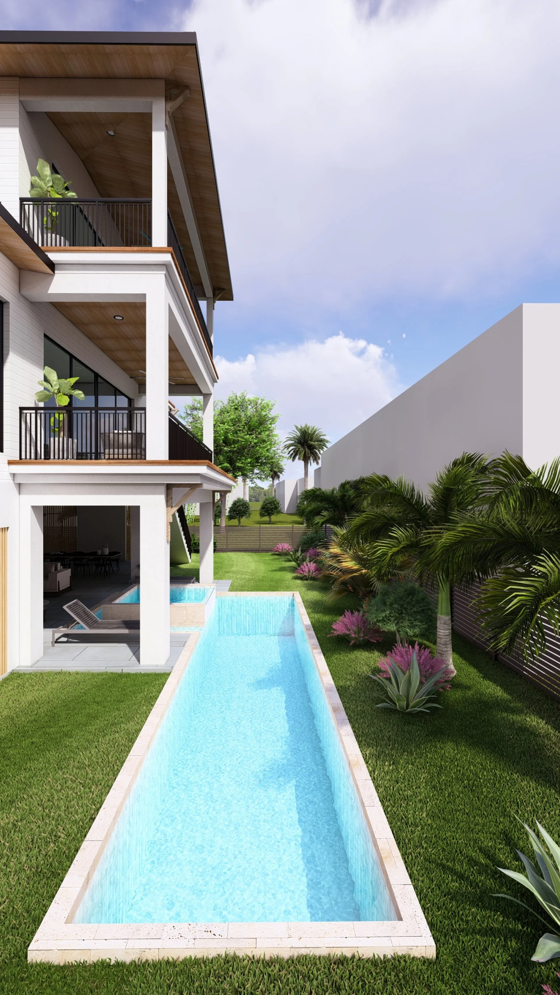 Modern multi-story residential building with balconies in lush green backyard featuring a narrow swimming pool, palm trees, and tropical plants under a partly cloudy sky.