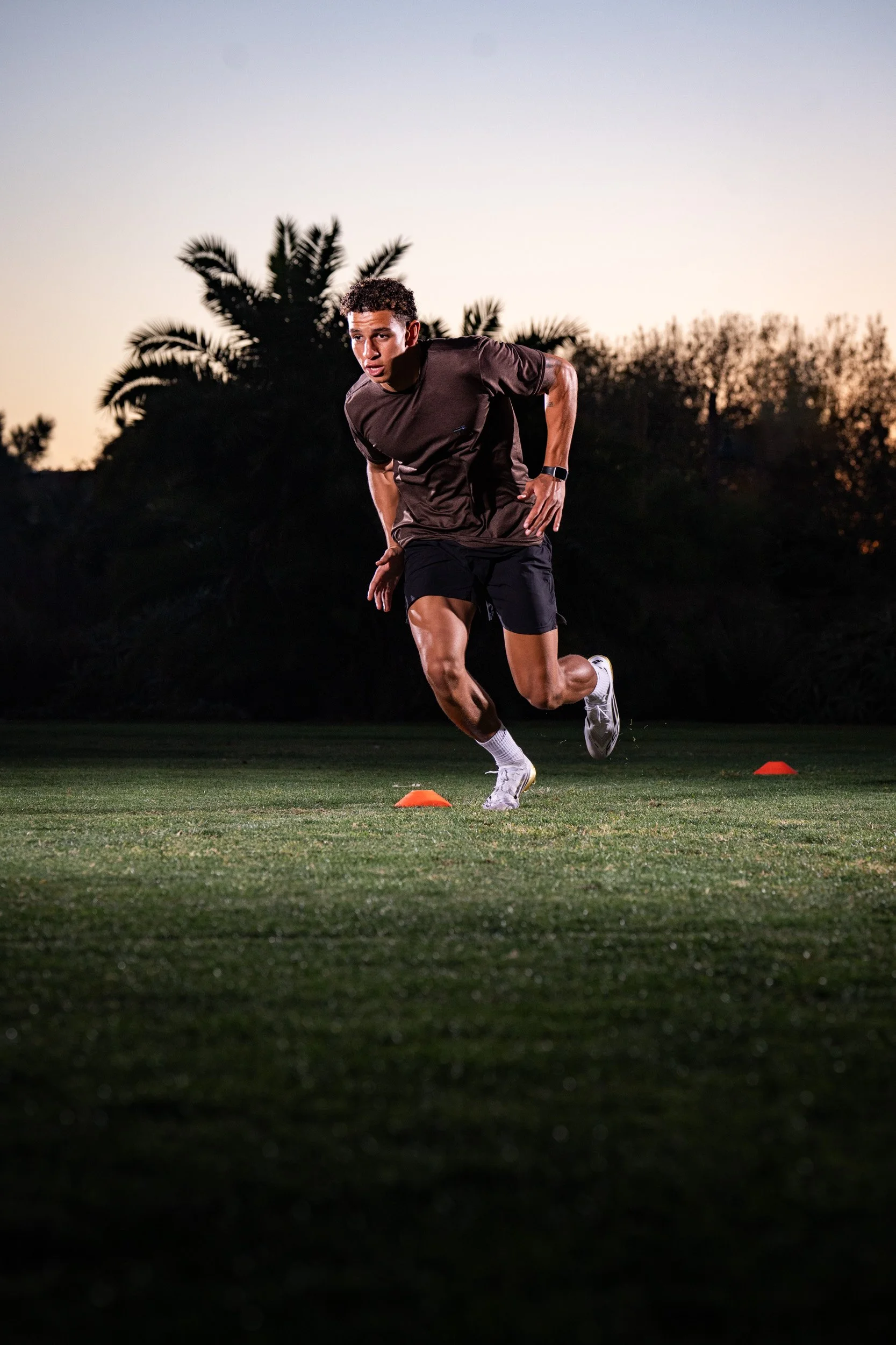 High school and college student athletes performing max velocity sprint training to improve top-end speed, stride efficiency, and athletic performance at Joe Dell Training.