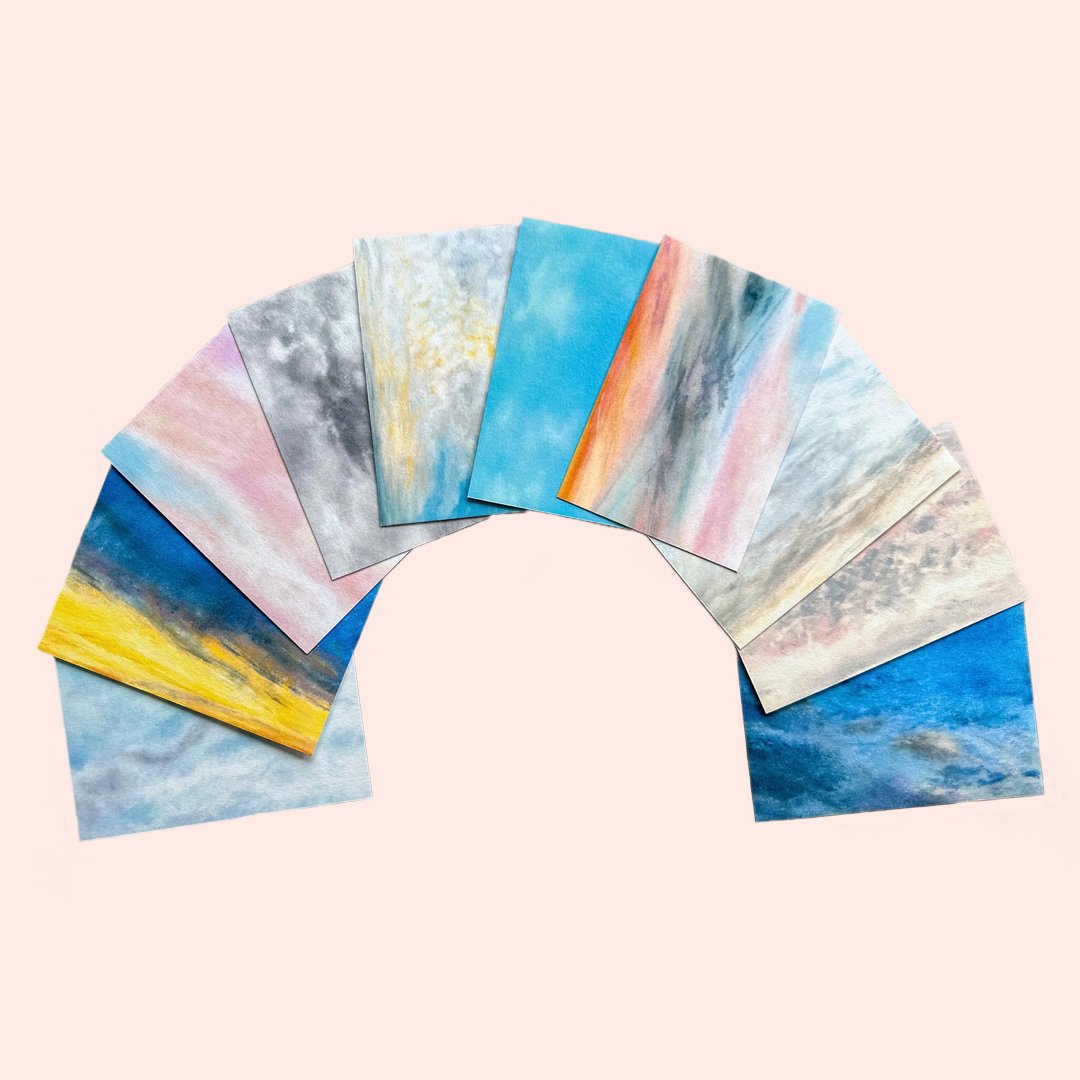 Through the Window postcard set laid out