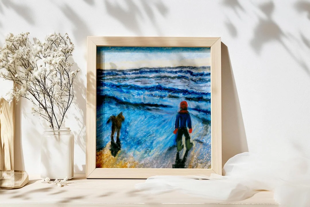 Framed watercolour print of a boy and his dog on the beach at sunset