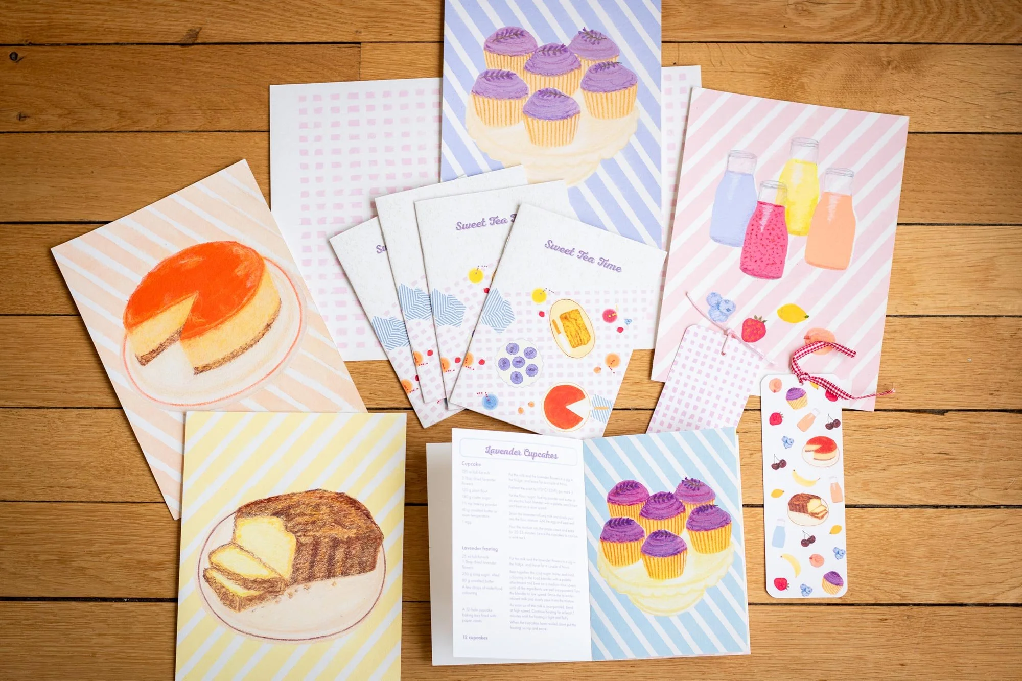 Illustrated recipe book with fuit smoothies recipe, lemon cake recipe, orange cheesecake recipe, lavender cupcakes recipe.