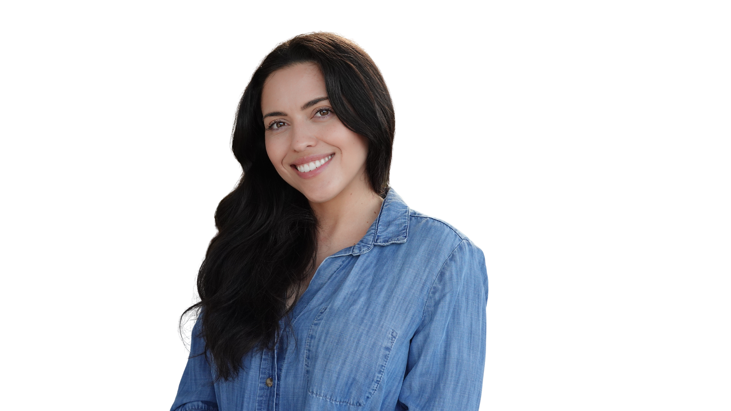 A young woman with long black hair and a bright smile, wearing a blue denim shirt, standing against a blurred background.
