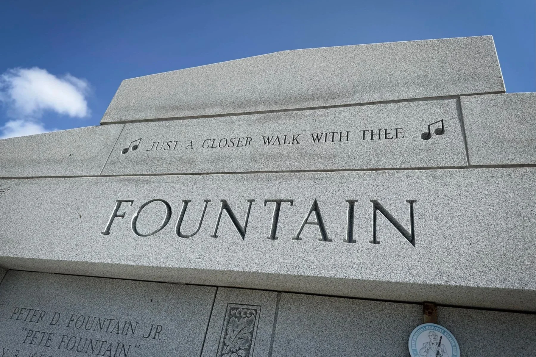 Pete Fountain family tomb engraved with “Just a Closer Walk with Thee” and musical notes at Metairie Cemetery in New Orleans.