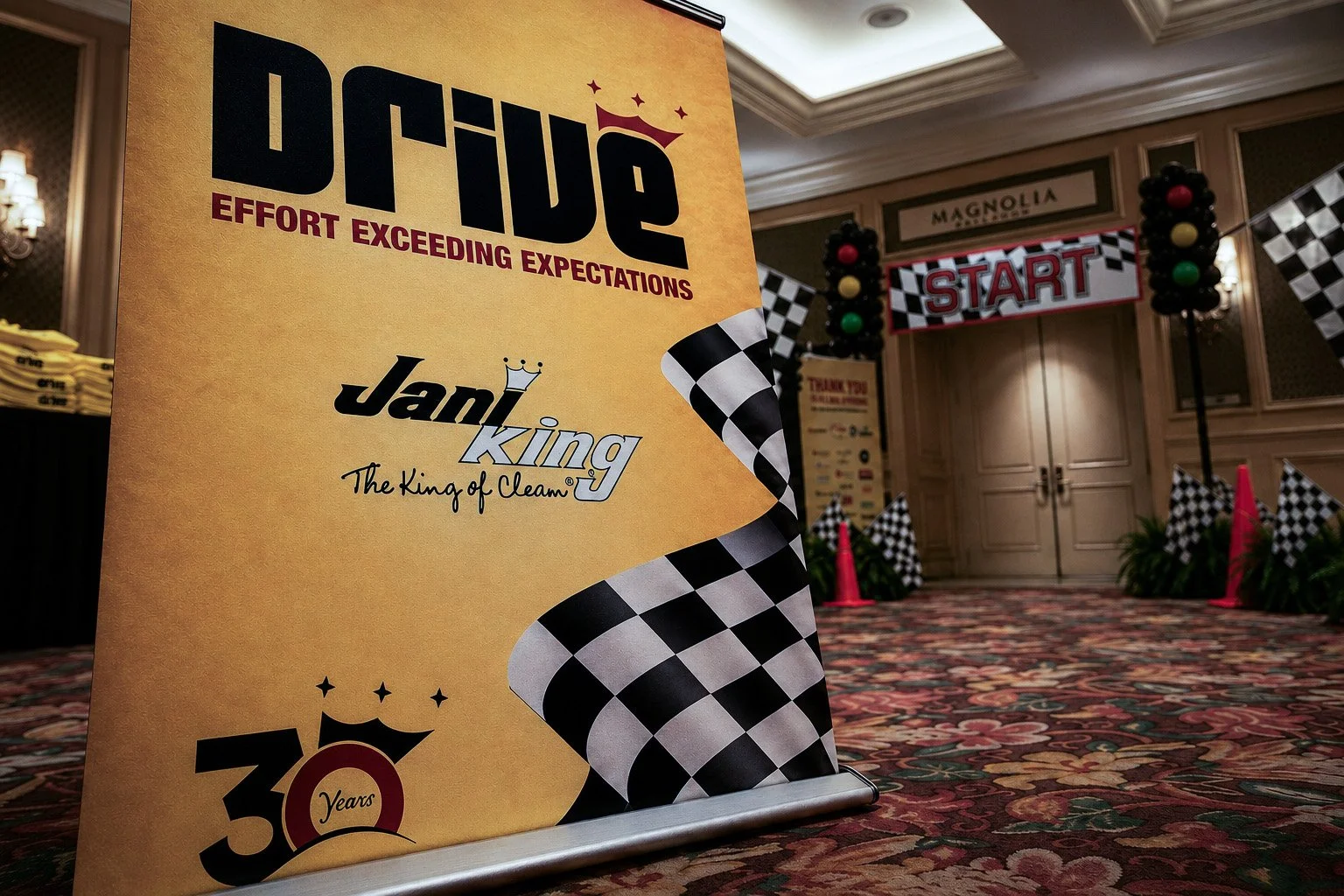 Jani-King DRIVE convention banner with checkered flags outside the Magnolia Ballroom at the Beau Rivage.