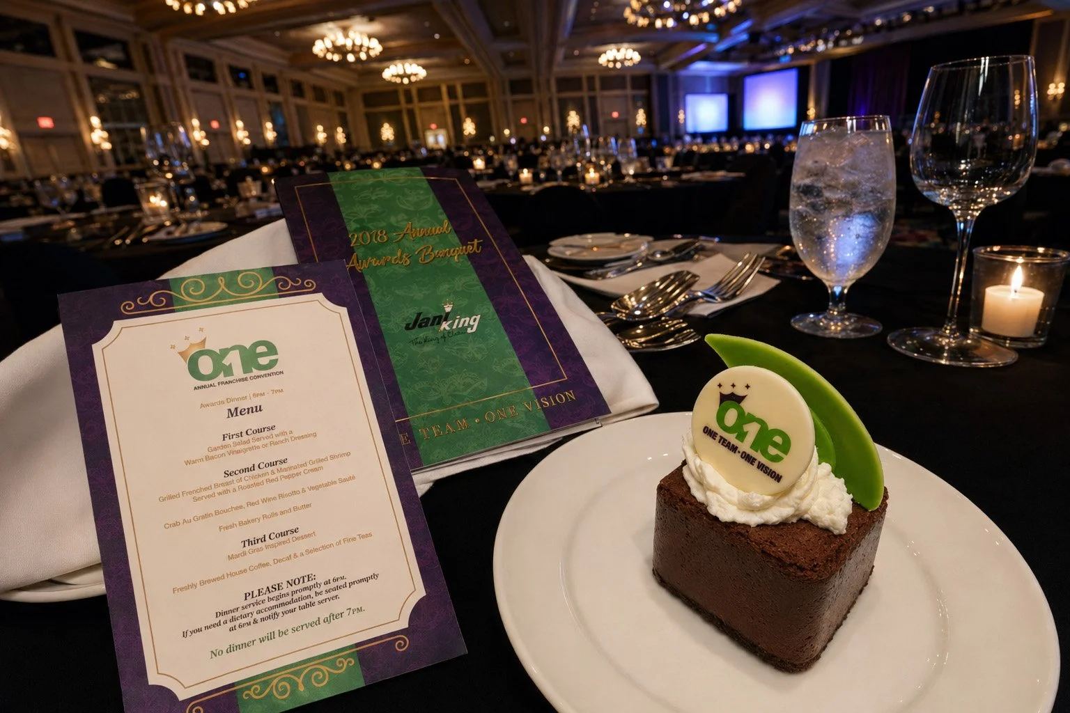 ONE convention menu, awards banquet program and branded chocolate dessert arranged at a formal table inside the Beau Rivage ballroom.