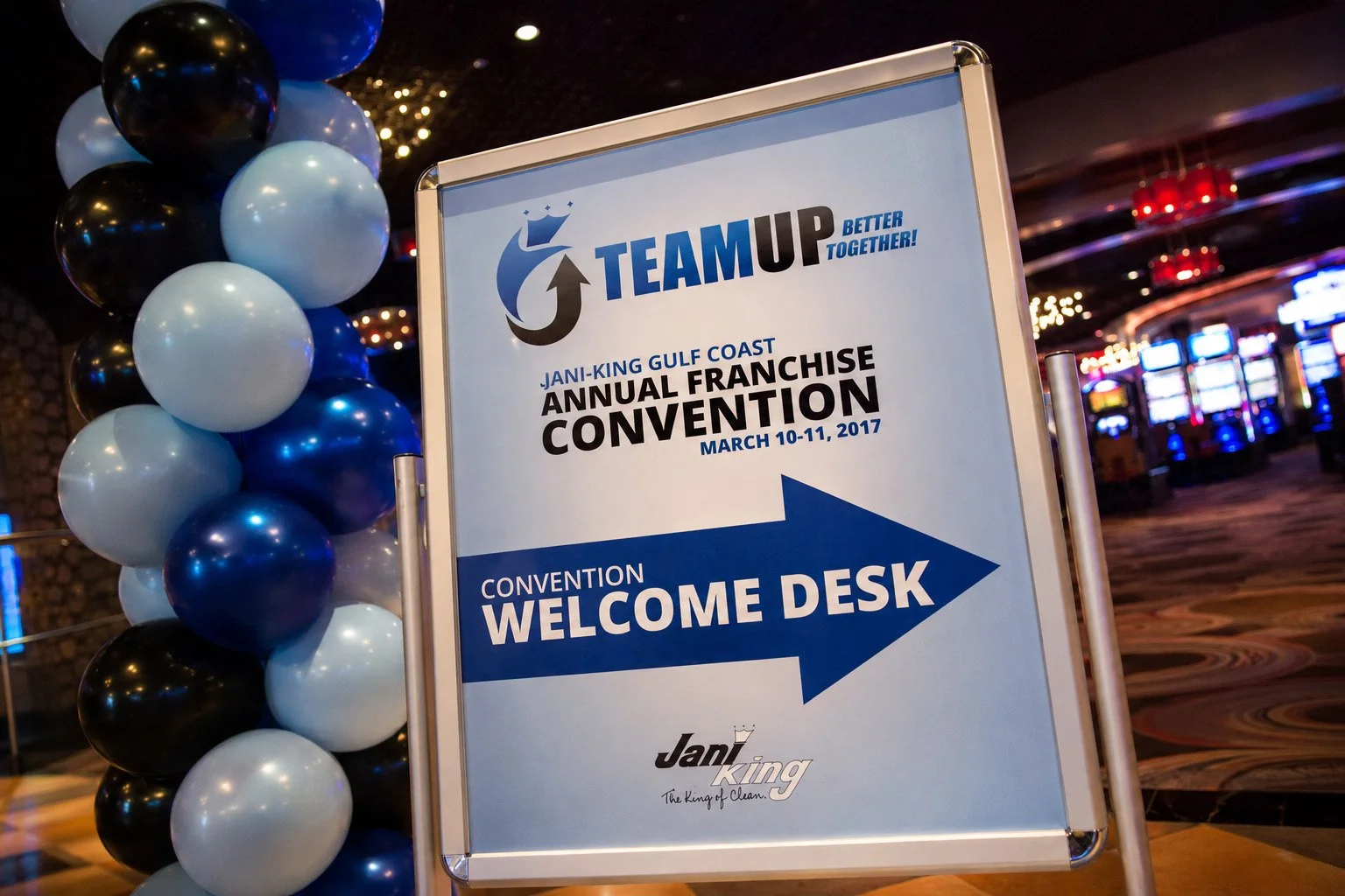 TEAM UP convention welcome sign beside blue, black and white balloons at Pearl River Resort.
