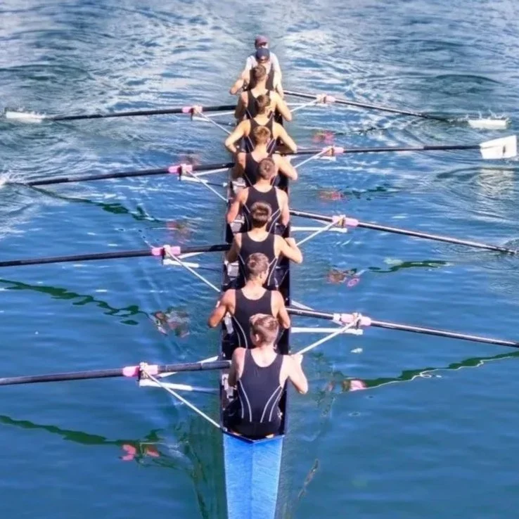 A synchronized rowing team moving in unison, symbolizing coordinated support and seamless collaboration at Gray Oak Capital.