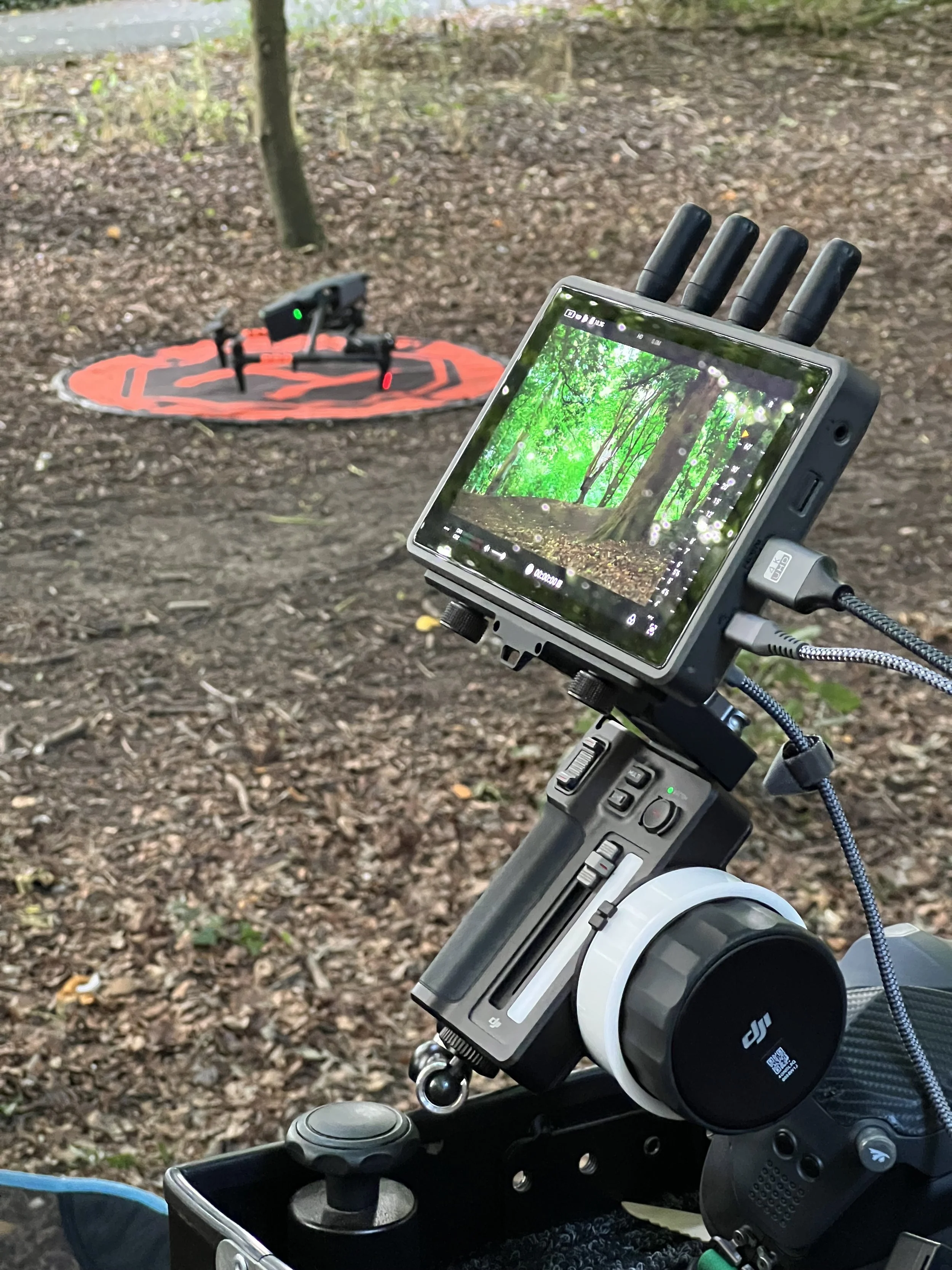 Grounded Media - the DJI High Bright monitor and DJI focus unit, connected to the DJI Inspire 3 in the forest