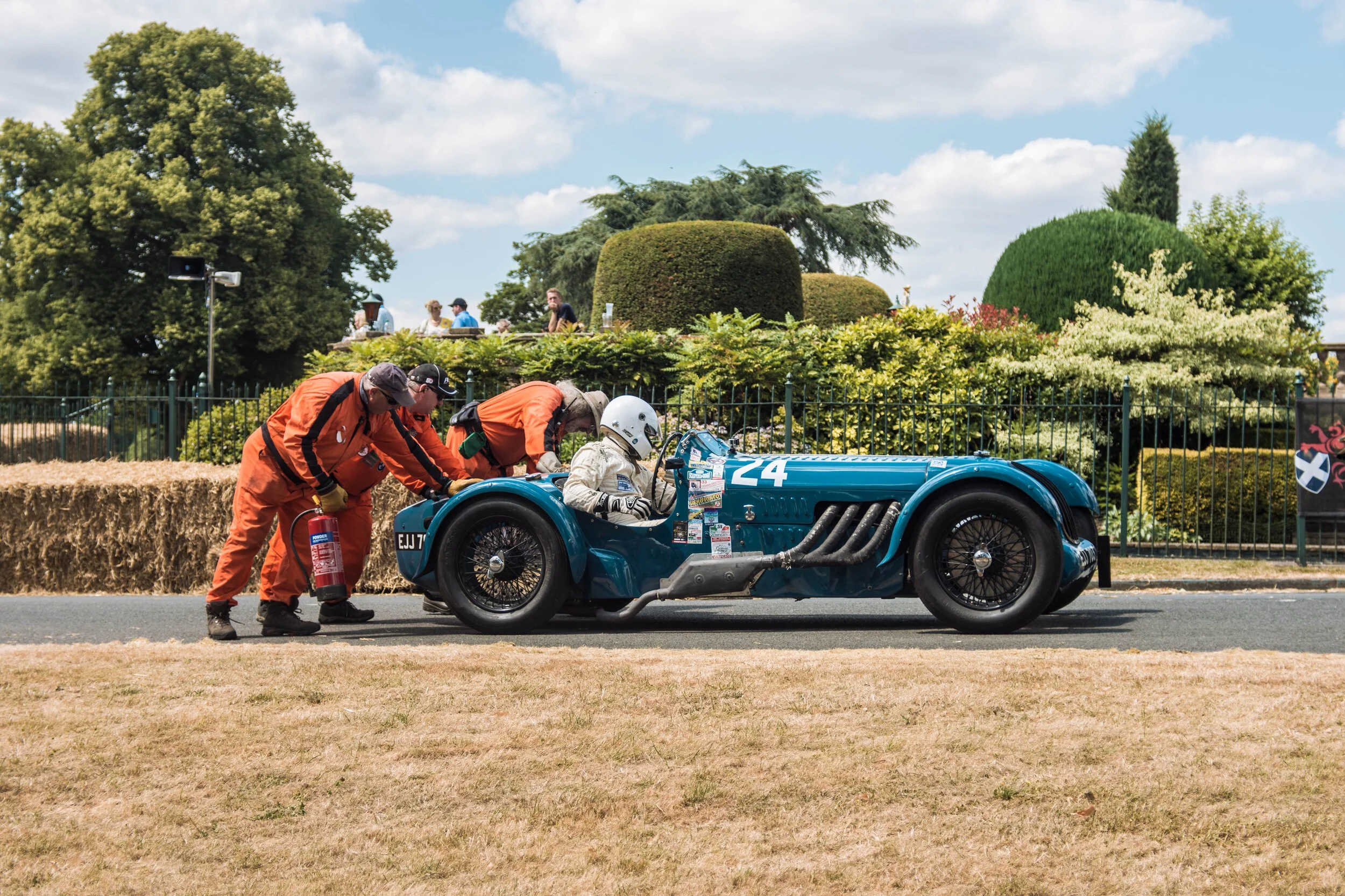 Grounded Media Photography Coverage of a vintage car hill climb. Surrounded by lush greenery and a pit crew. Image taken by Stan Thornton