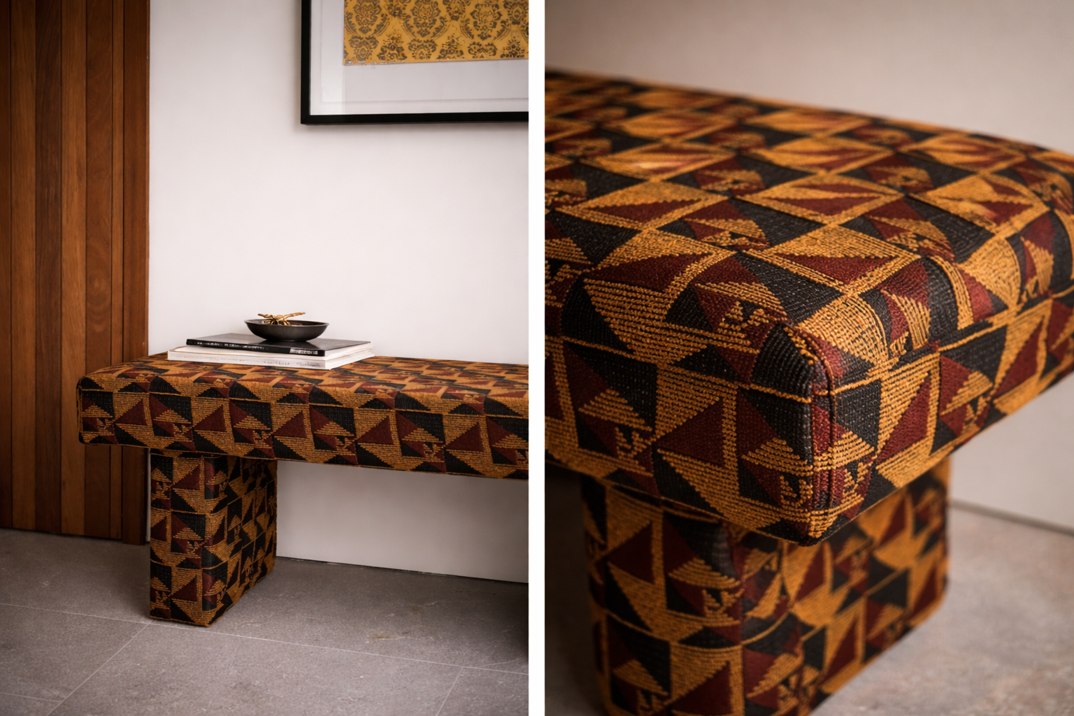 A bench with a geometric patterned fabric in colors of black, red, and yellow, placed against a white wall with framed artwork and a wooden panel. A black bowl and some books are on top of the bench.