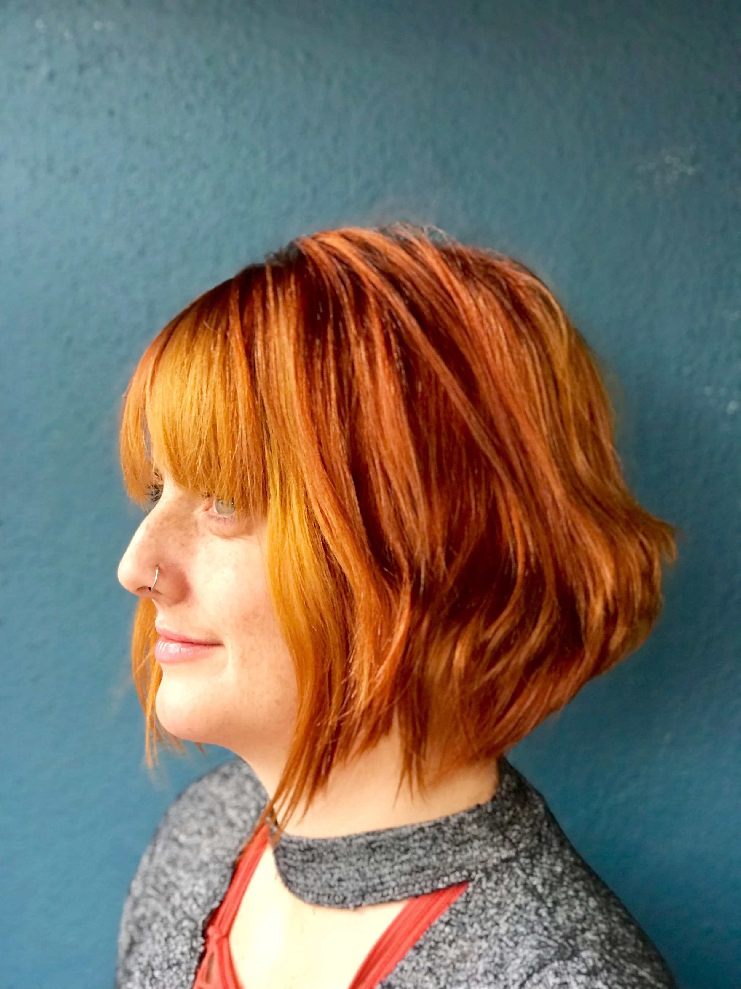 After: Copper red short bob hair cut with bangs