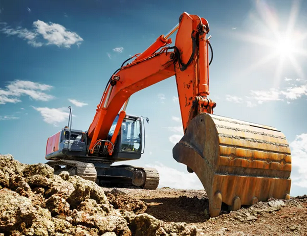 large red excavator grating land