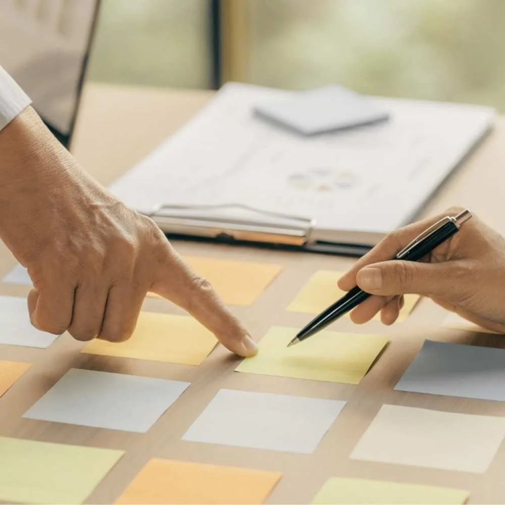 finger pointing to a sticky note