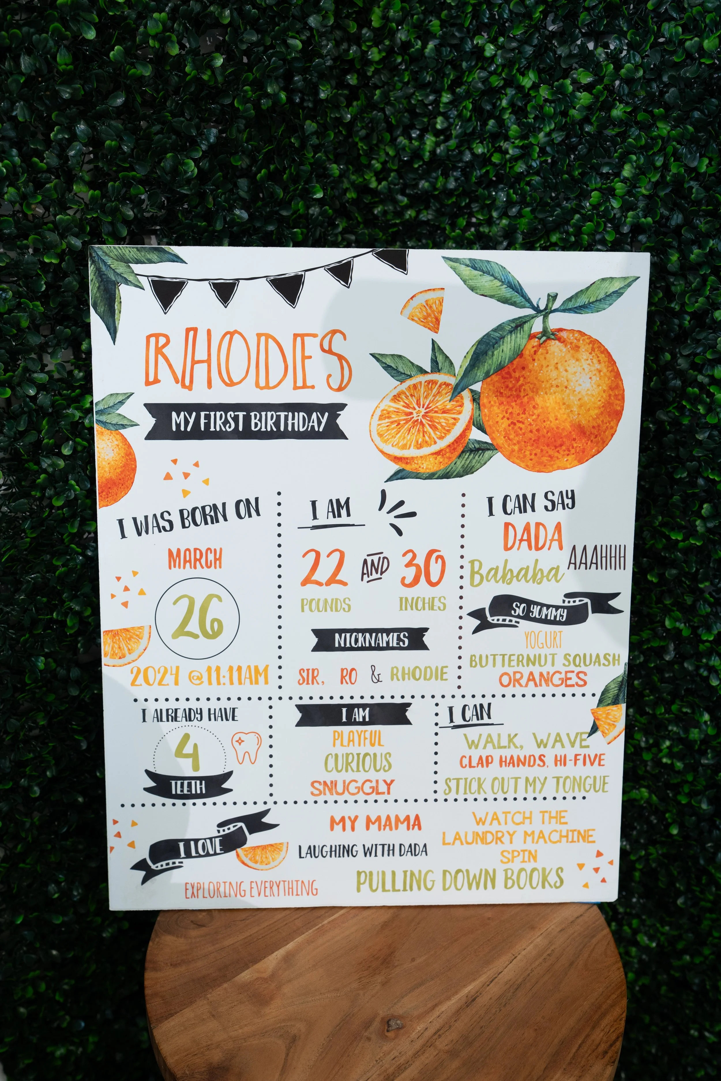 A decorative birthday poster for a child named Rhodes, featuring oranges and citrus-themed illustrations, with sections for personal details, nicknames, likes, and dislikes.
