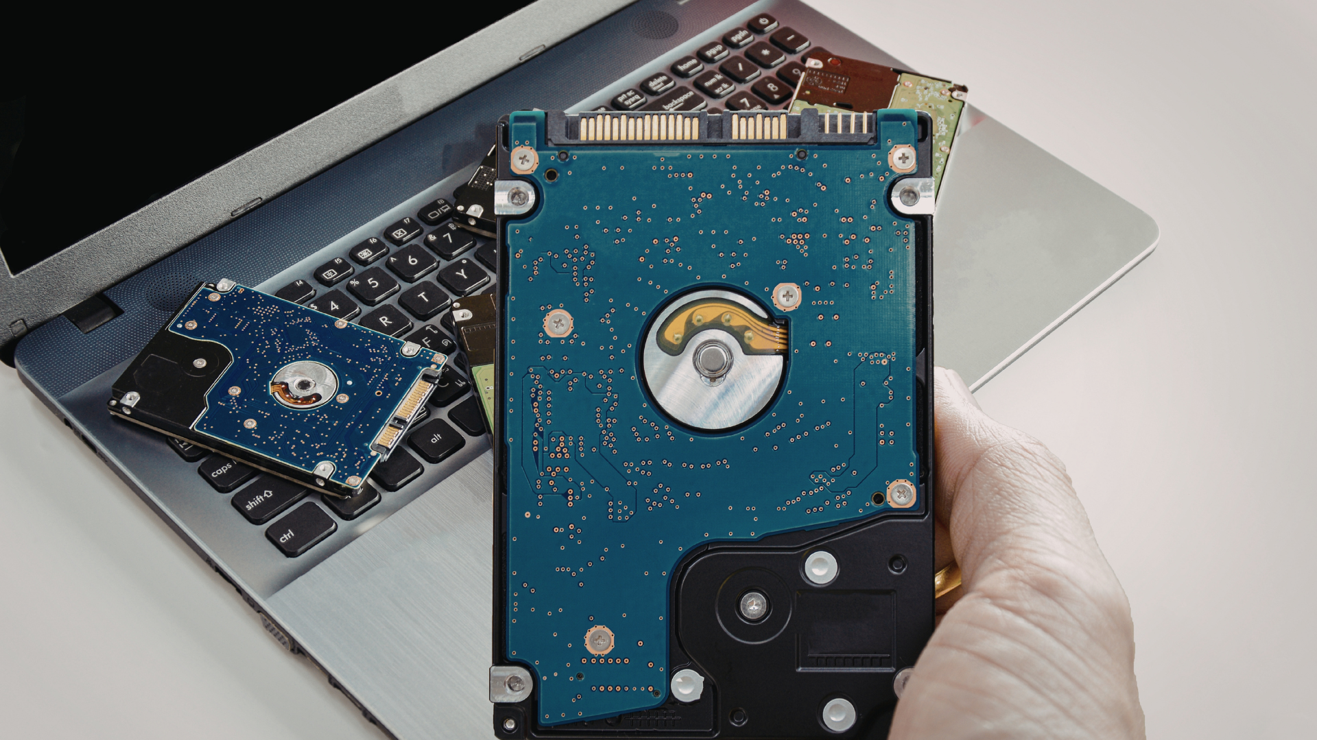 Hand holding physical hard drive