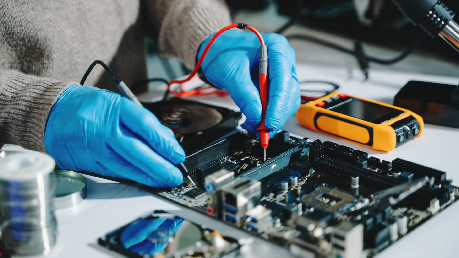 Close up of hand fixing electronics