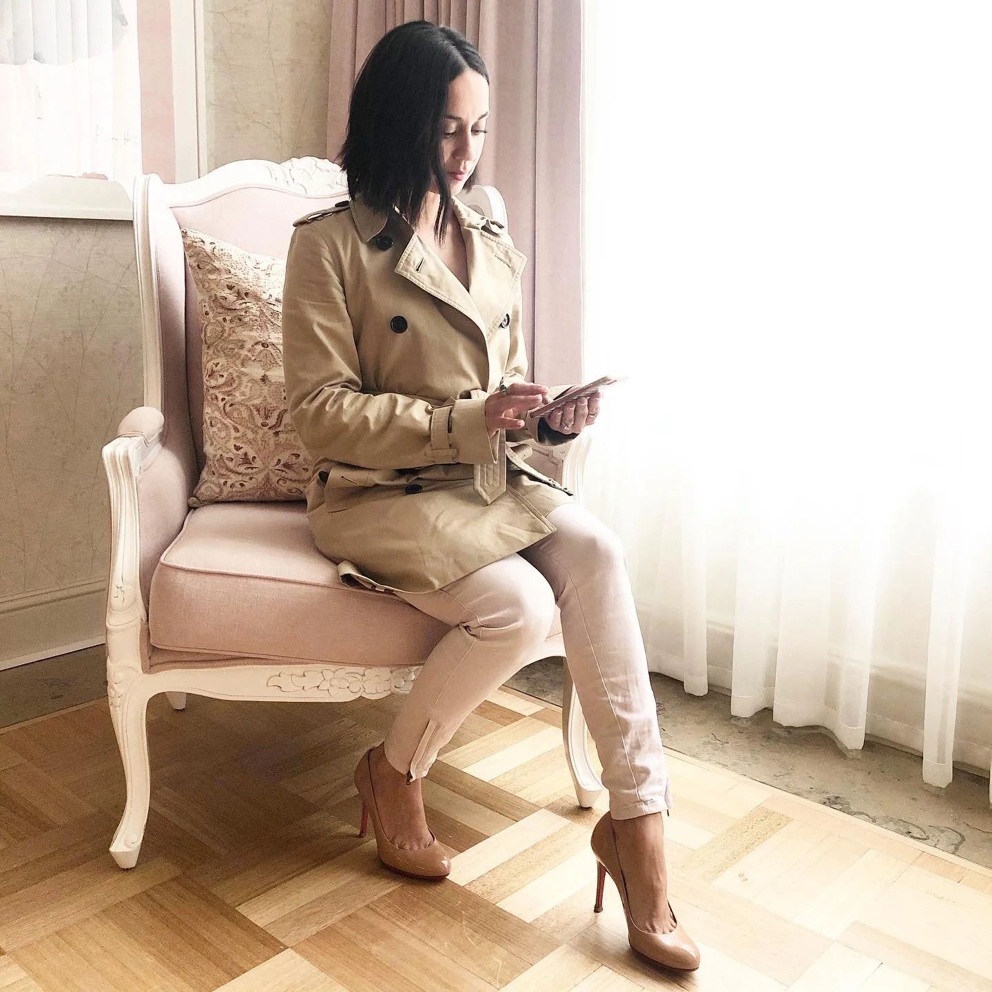 Wendy Russell in a trenchcoat on the phone