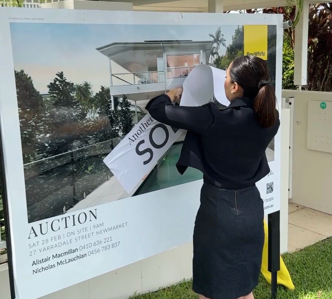 Wendy Russell Buyers Advocate putting sold sticker on property in Newmarket Brisbane