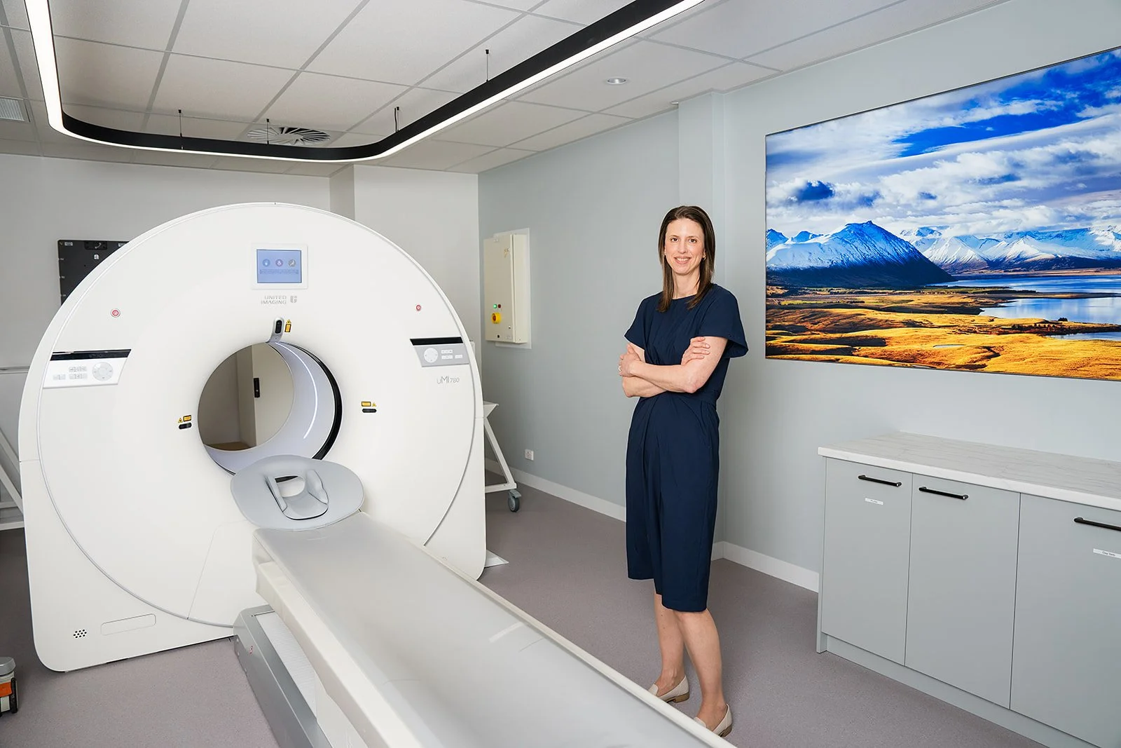 Dr standing next to a PET CT