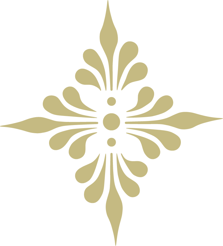 Gold-colored decorative symmetrical pattern with teardrop shapes and dots, resembling an ornate floral or starburst design.
