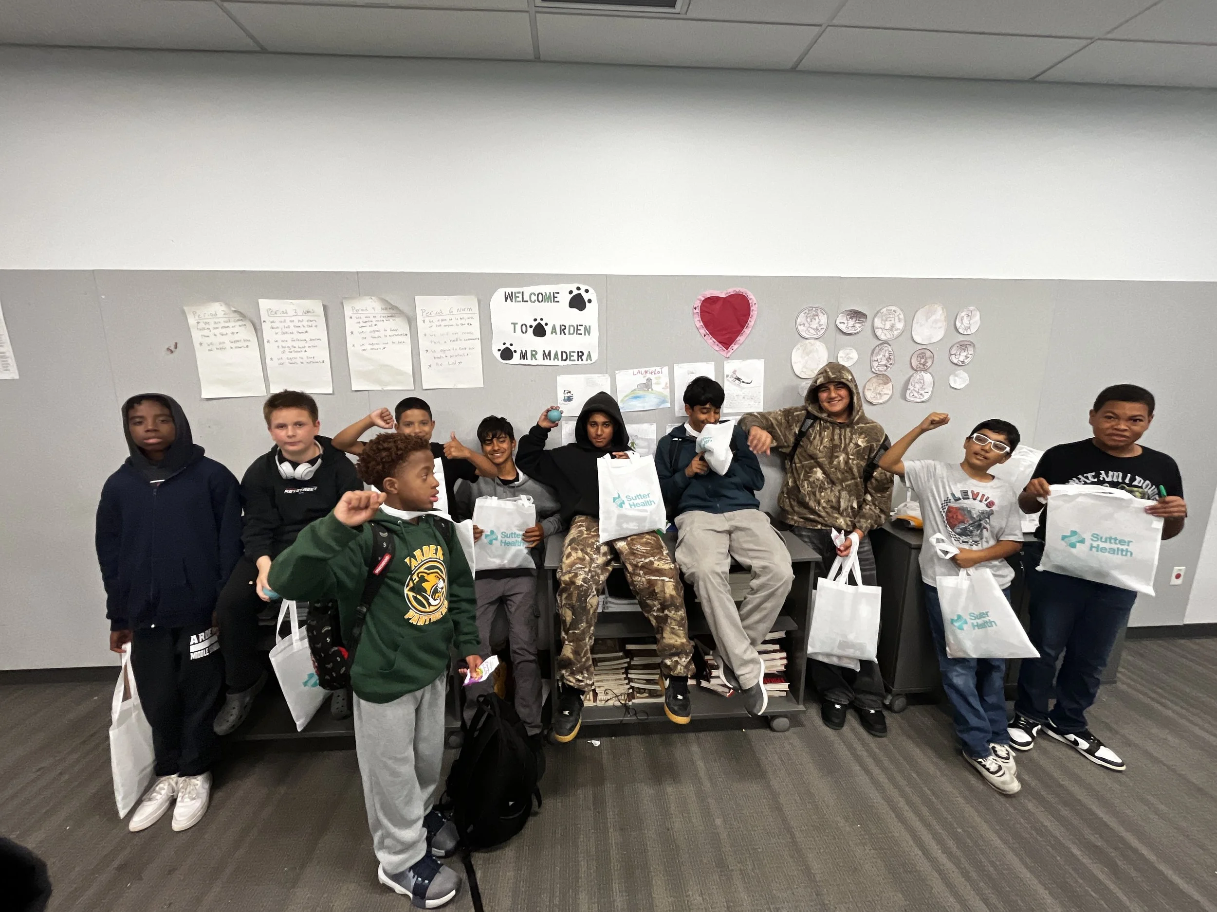 Students hold up health kits