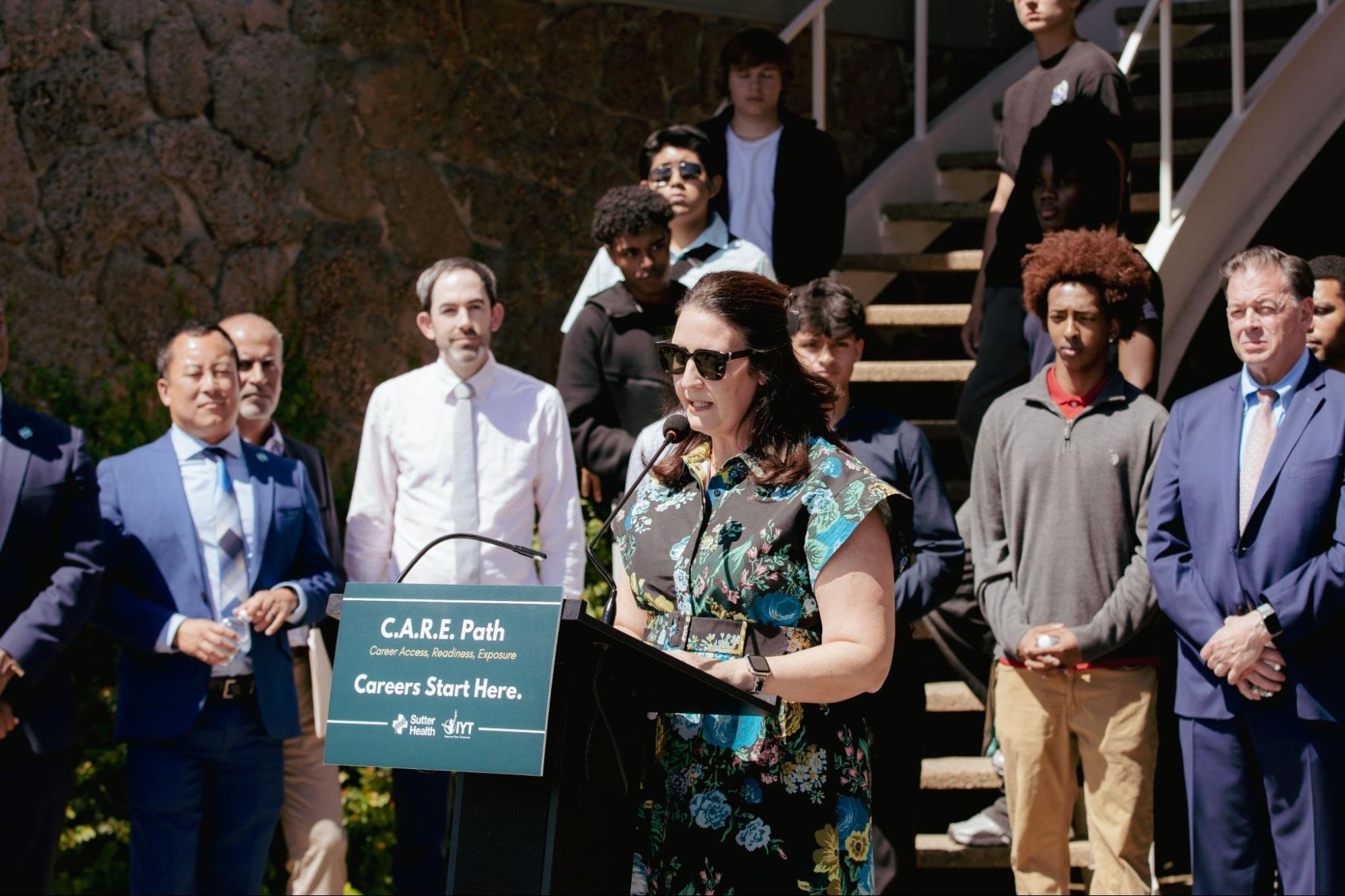 Sutter Health leadership member gives a speech at a partnership launch event.