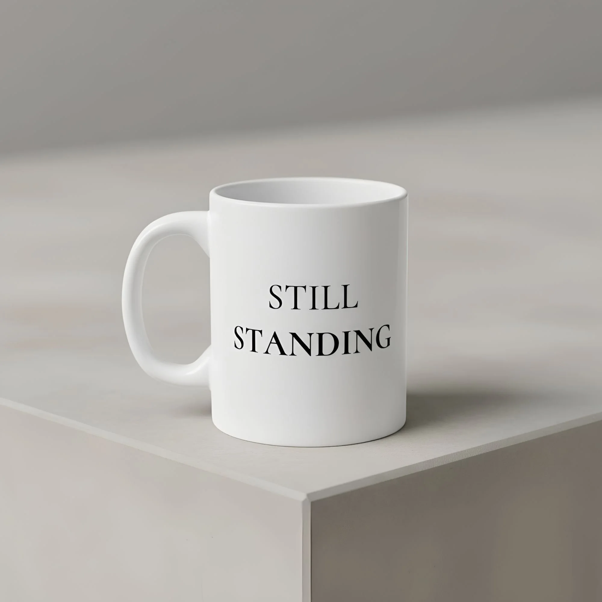 Still Standing 11 oz white ceramic mug on neutral gray concrete surface