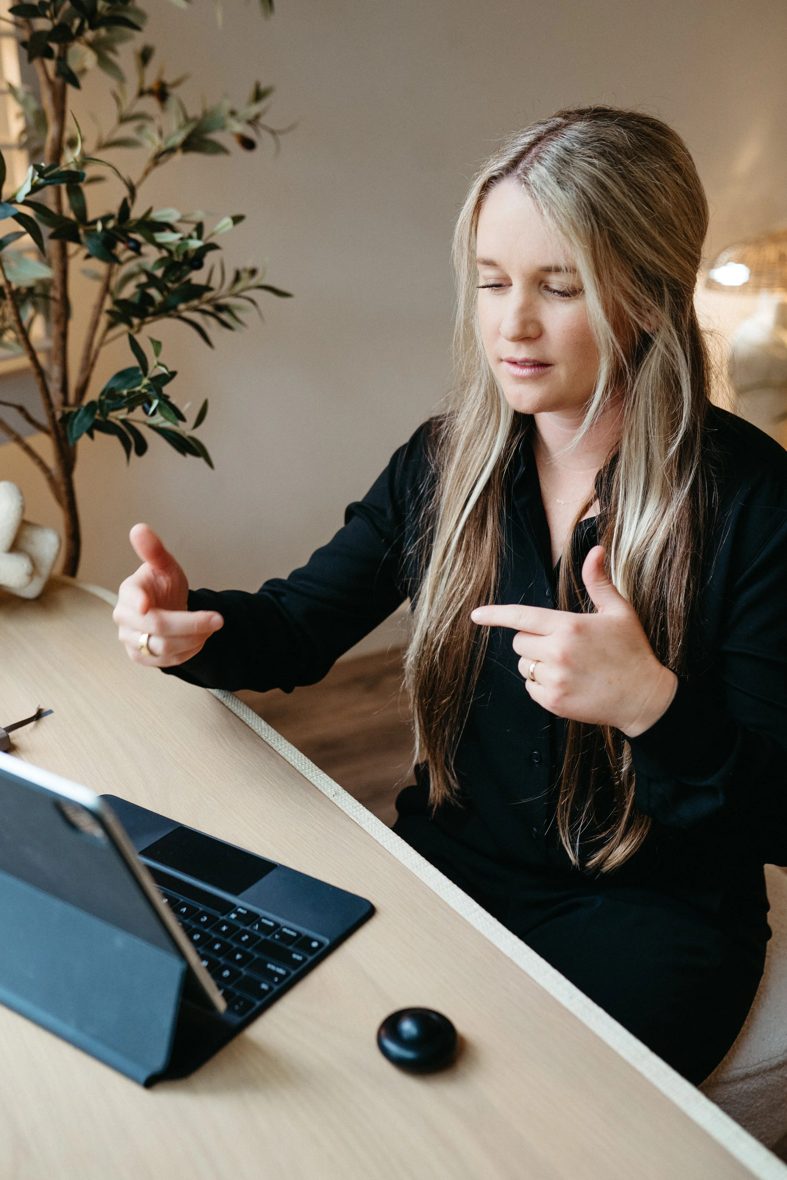 Photo of a therapist in the Nido office conversing through a screen with a client