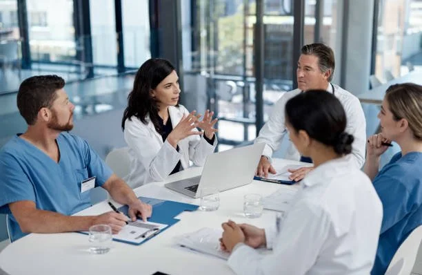 Medical professionals in a meeting room discussing.