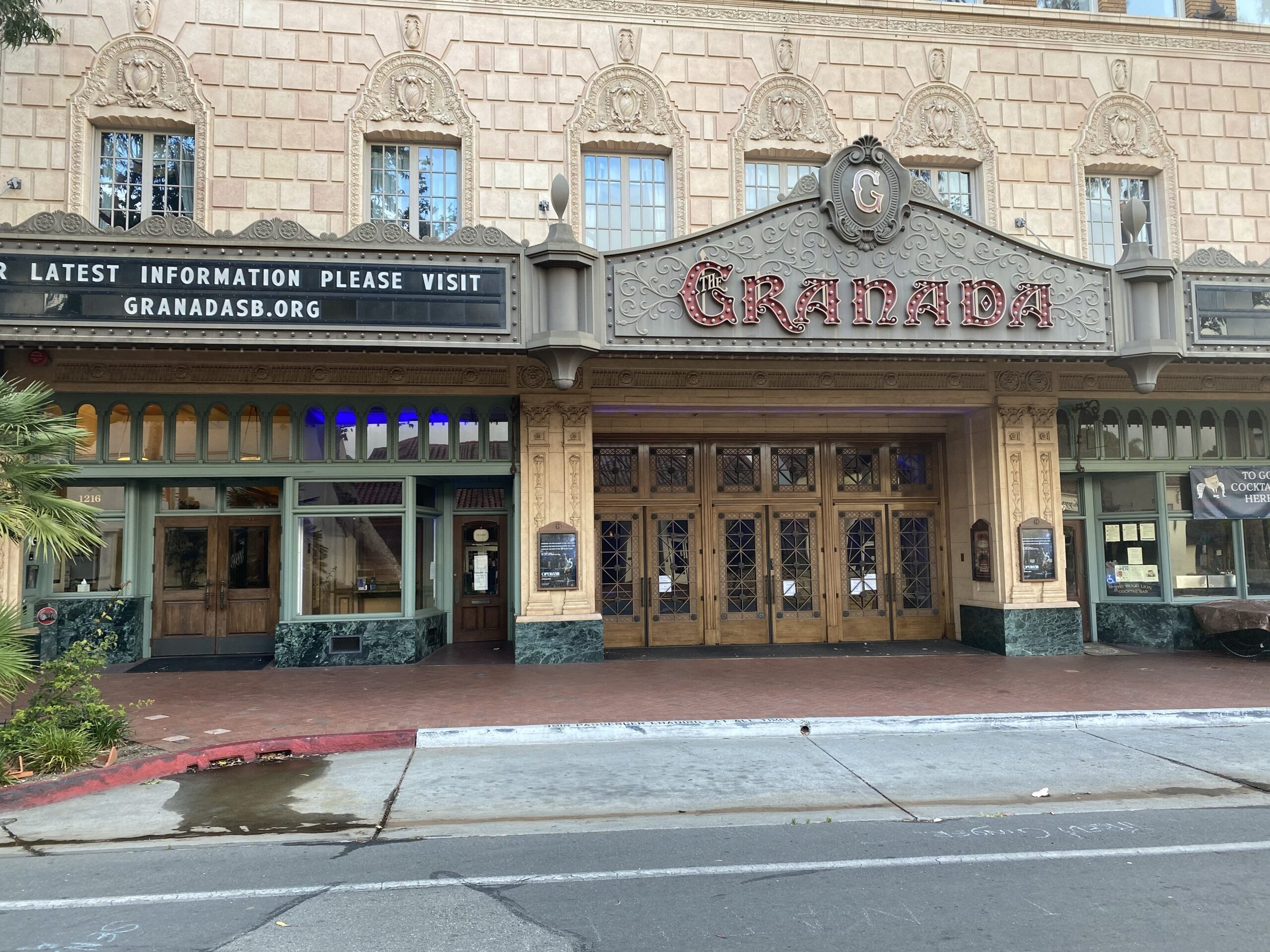 The front facade of the Granada theater with ornate architectural details, a marquee that says 'The Granada'.