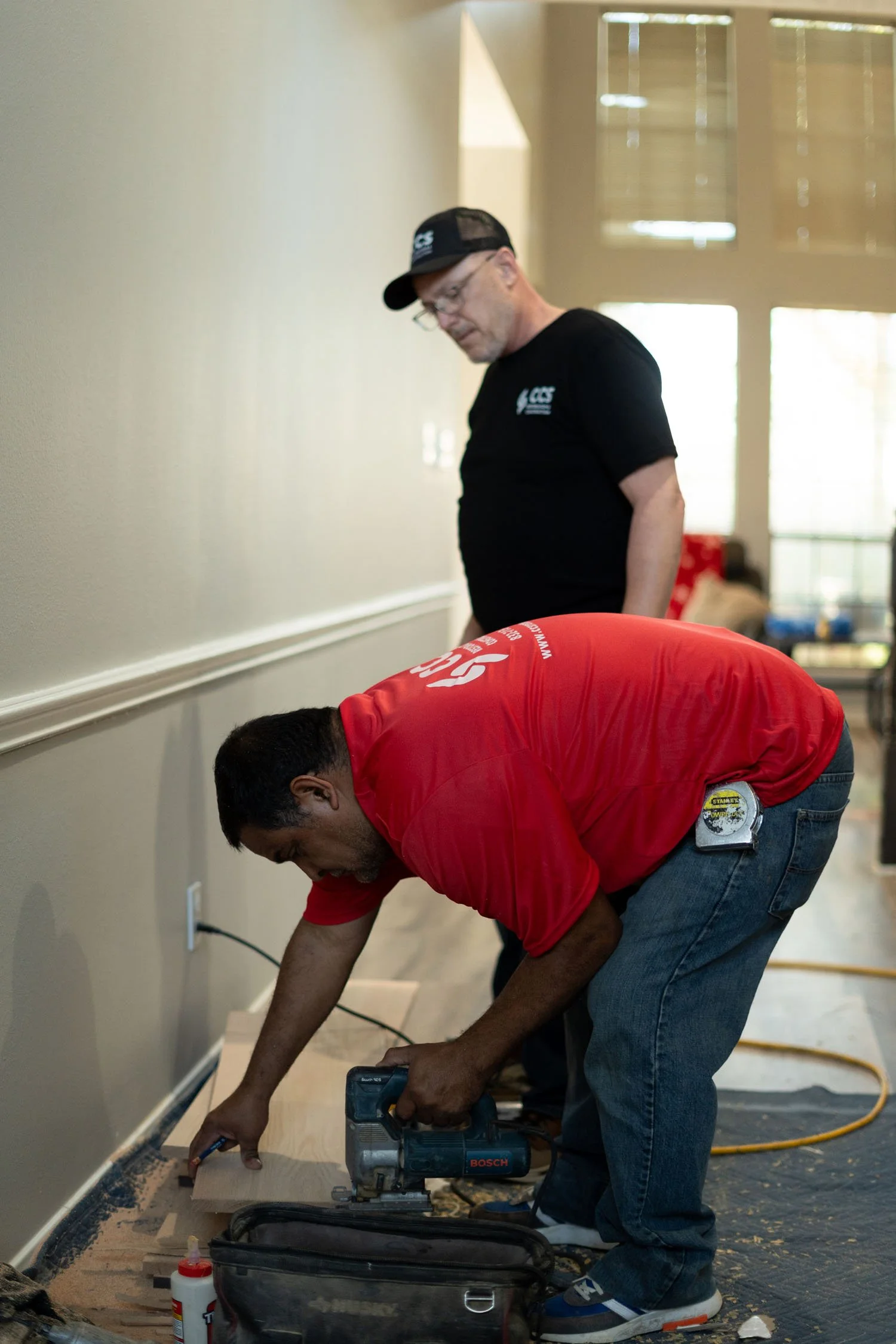 CCS Restoration and Construction workers installing wood flooring