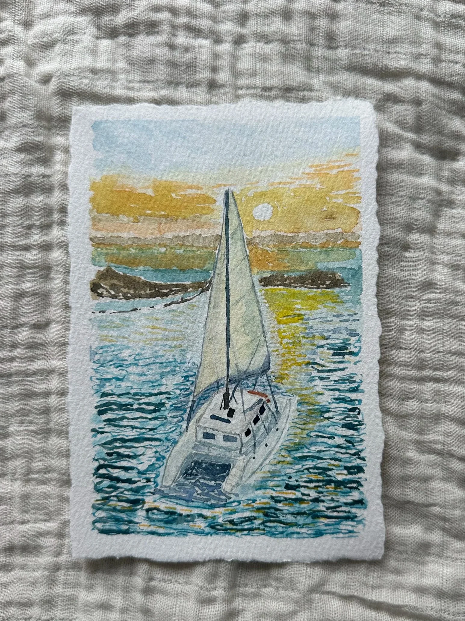 Watercolor painting of a sailboat on the water during sunset with a yellow-orange sky and the moon visible in the background.