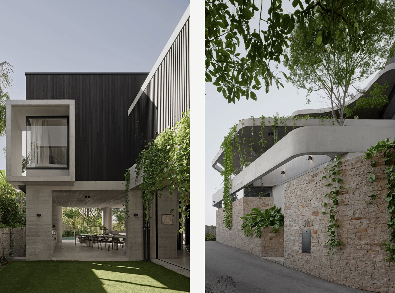 Two modern residential buildings with unique architectural designs. The left building features a black exterior with a large window encased in a concrete frame, an open ground level with outdoor dining furniture, and a grassy lawn. The right building