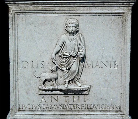 Relief showing ancient Roman boy and his dog