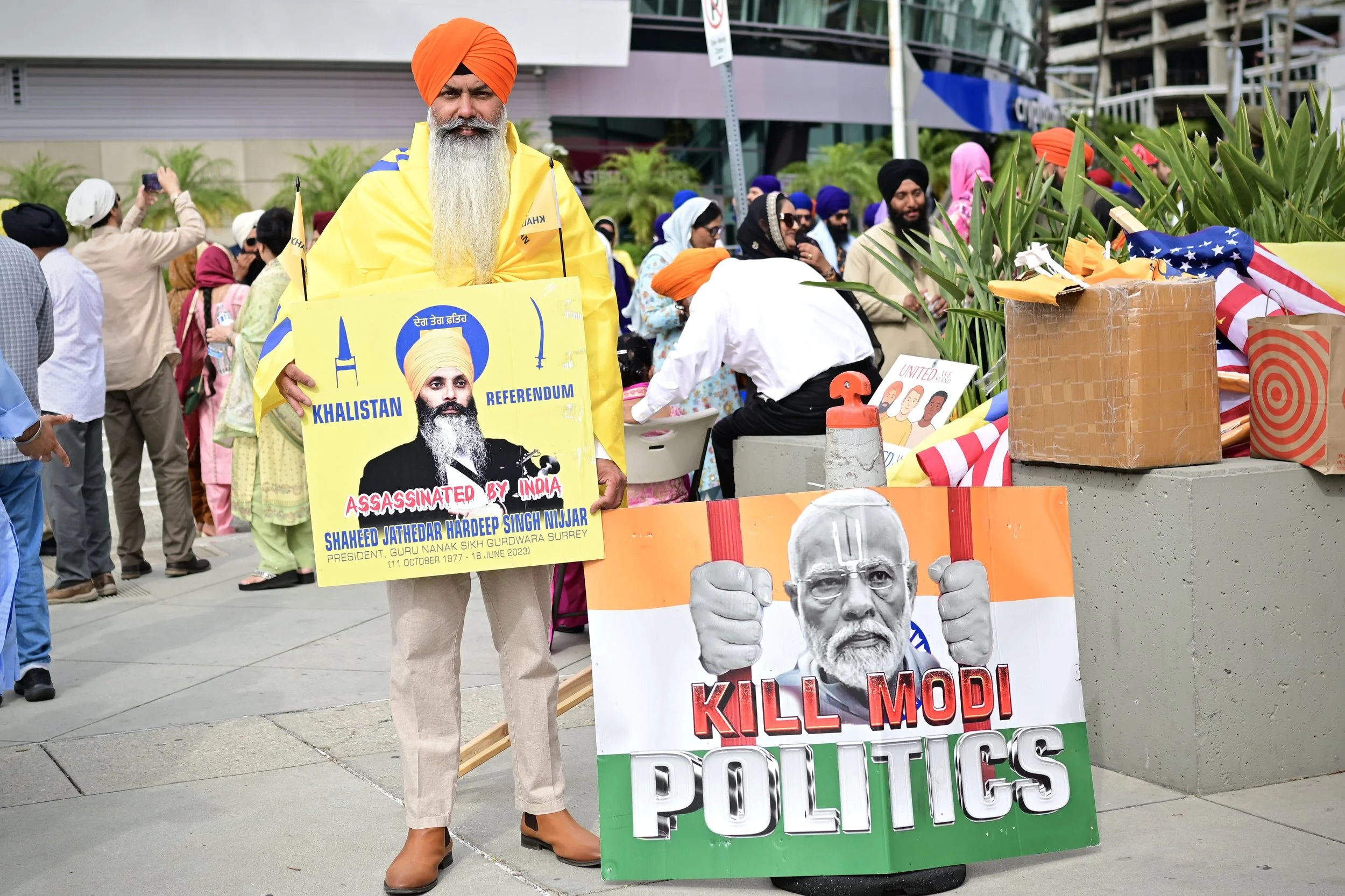 Sikh man displaying a sign Hardeep Singh Nijjar, who was assassinated in 2023 in a Sikh temple parking lot. The other sign displaying the Prime Minister of India. (Los Angeles) 