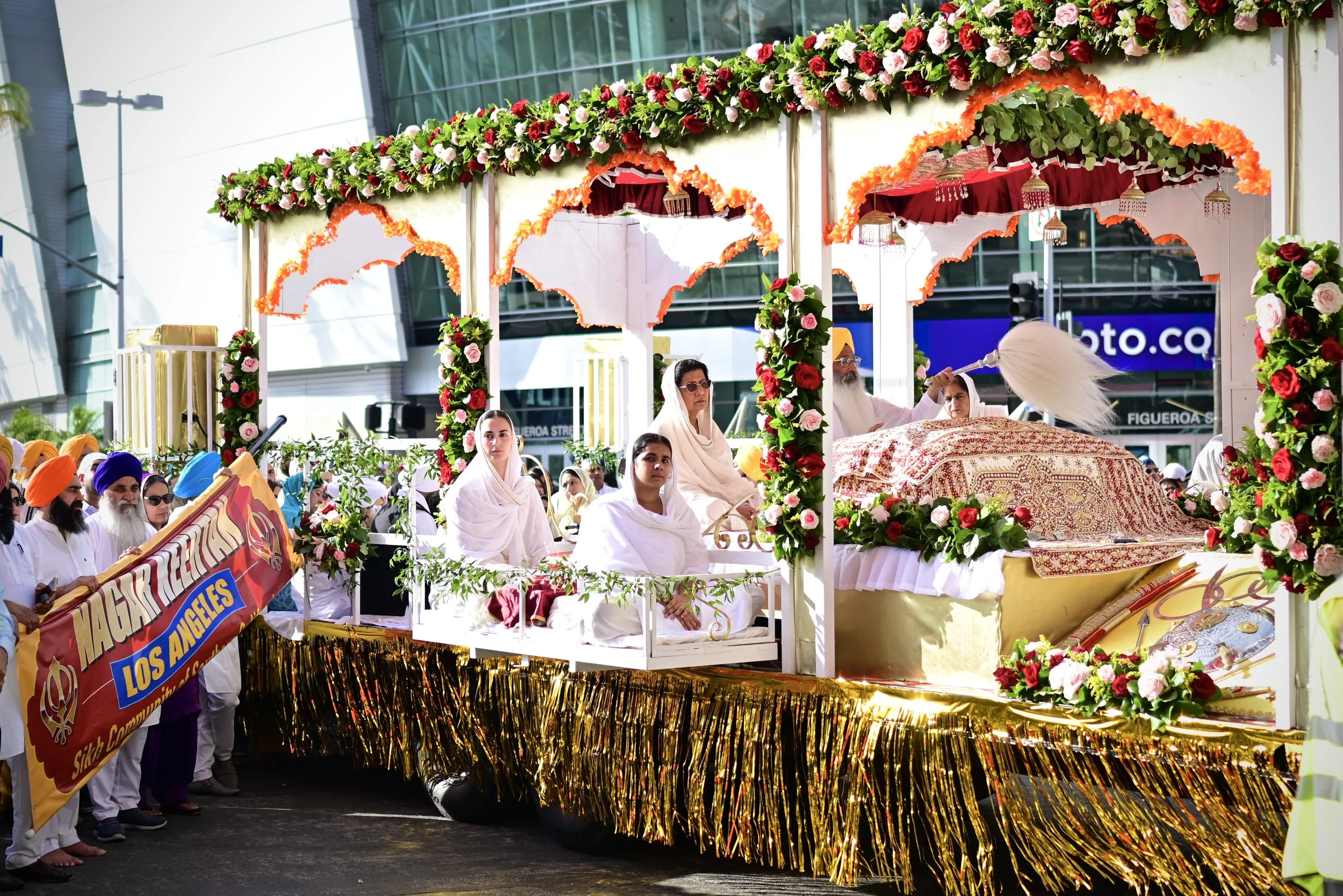A float holding the Guru Granth Sahib, the religious living scripture of Sikhism originating from 1604. It contains thousands of spiritual poems and religious hymns from Sikh, Hindu and Muslim religious scholars. (Los Angeles, 2026) 