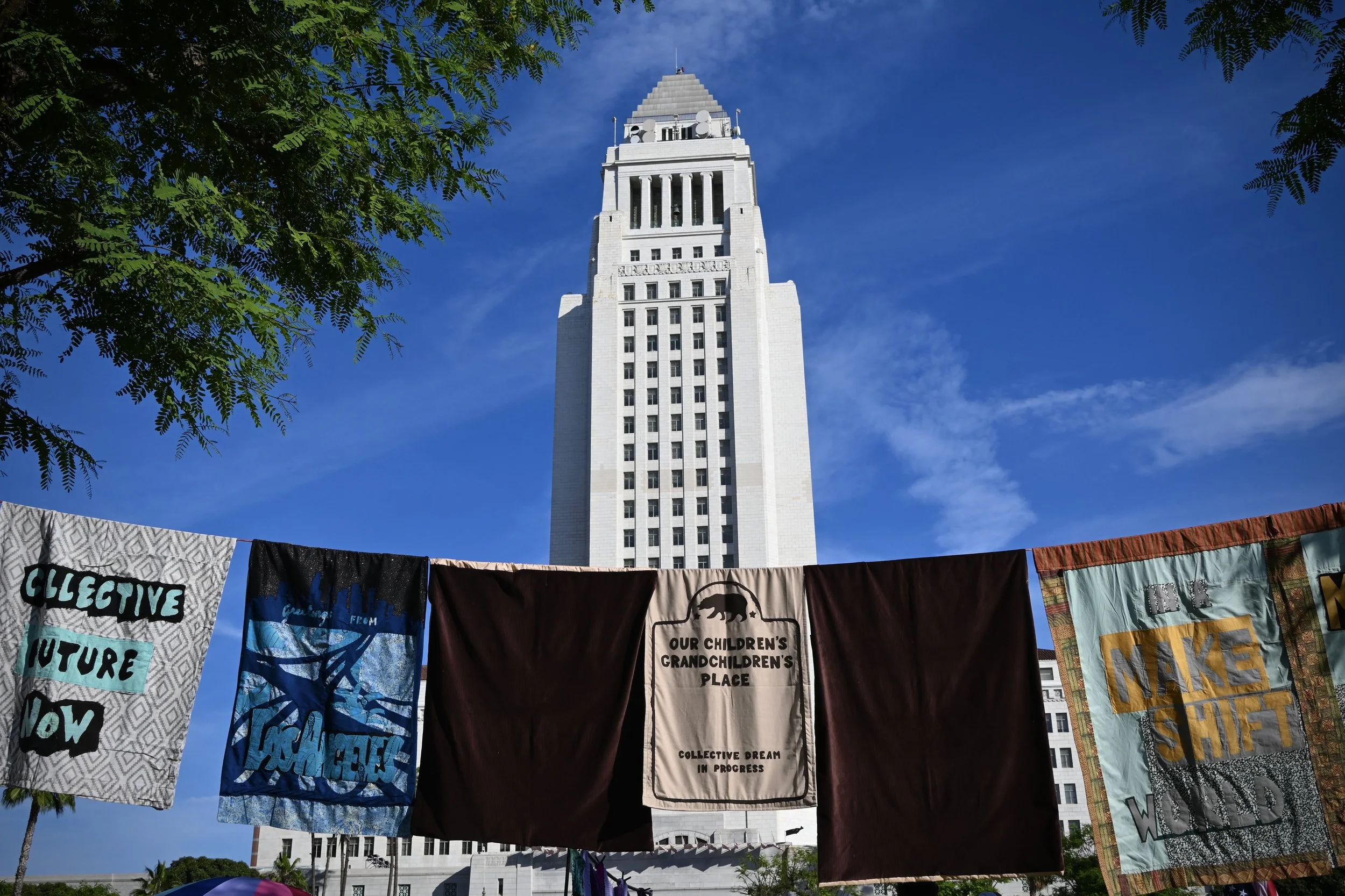 Blankets and quilts in front of city hall. (Los Angeles, 2026)