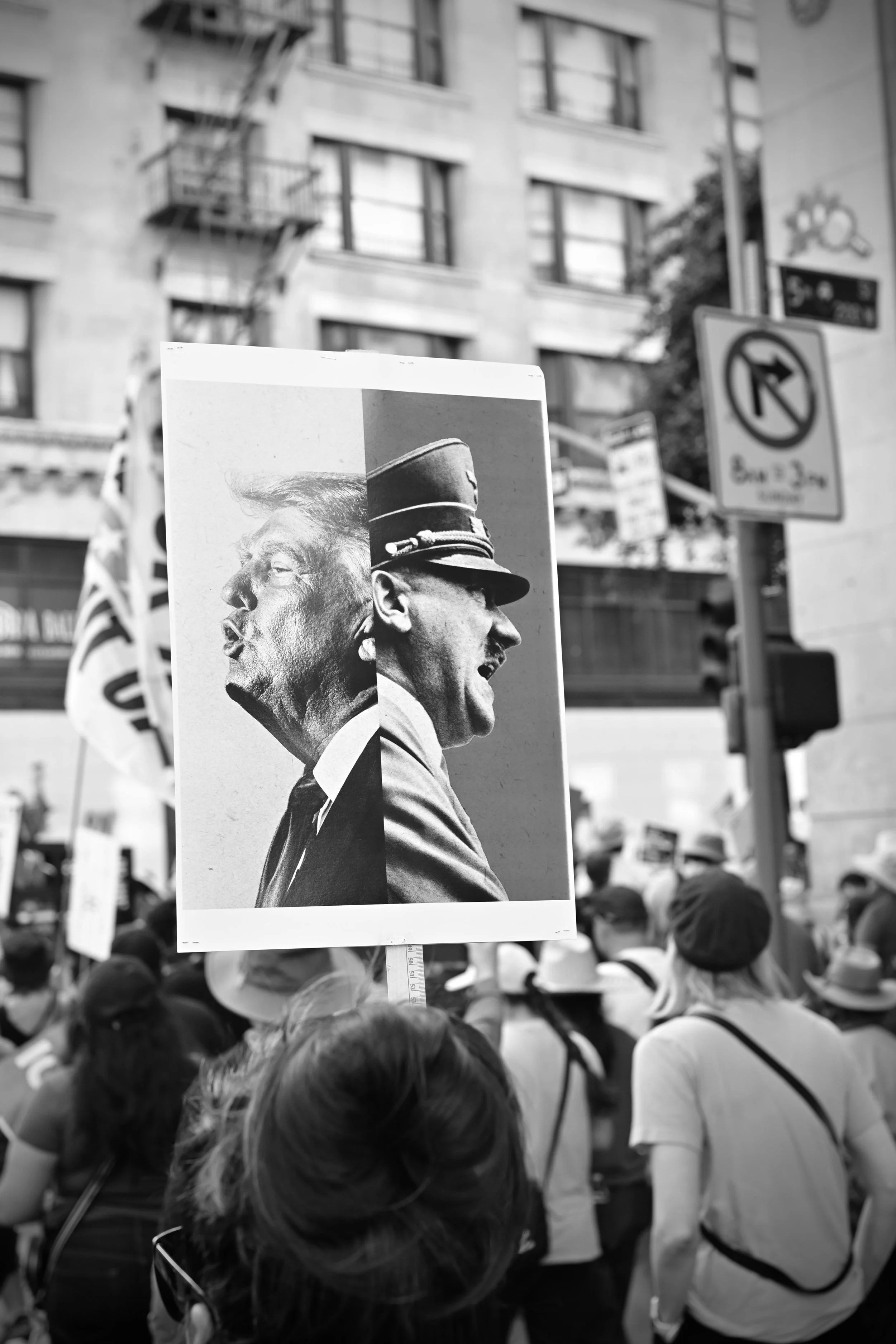 A sign with Donald Trump and Adolf Hitler. (Los Angeles, 2026).