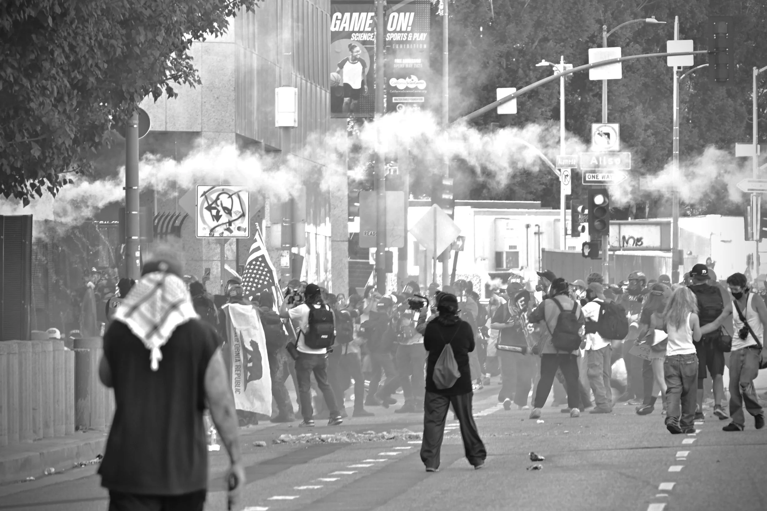 A cloud of tear gas erupts as protesters throw tear gas canisters back toward officers after grenades were deployed outside the Los Angeles Metropolitan Detention Center. (Los Angeles, 2026)
