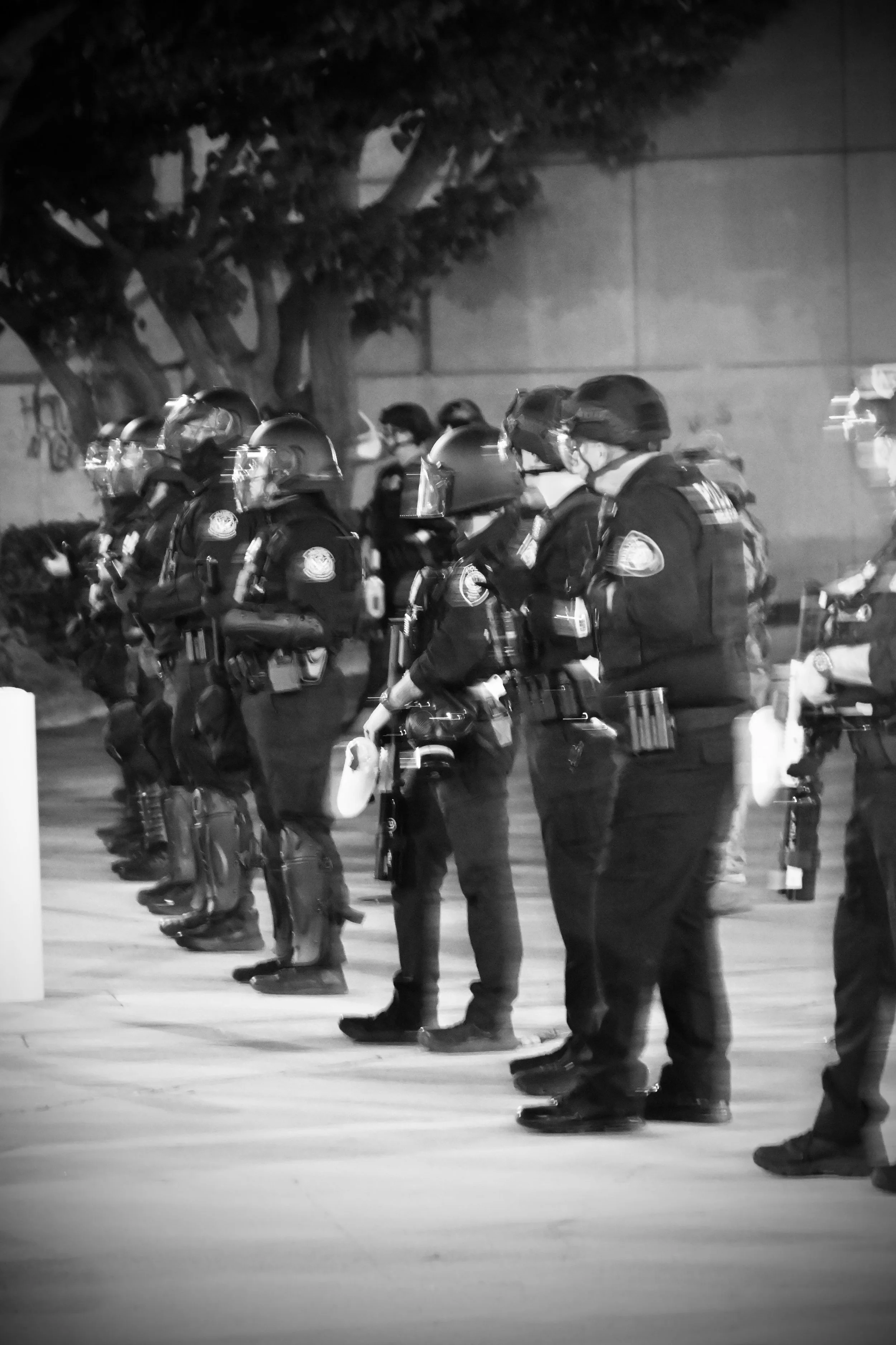 DHS agents and ICE officers stand facing the crowd. (Los Angeles, 2026)