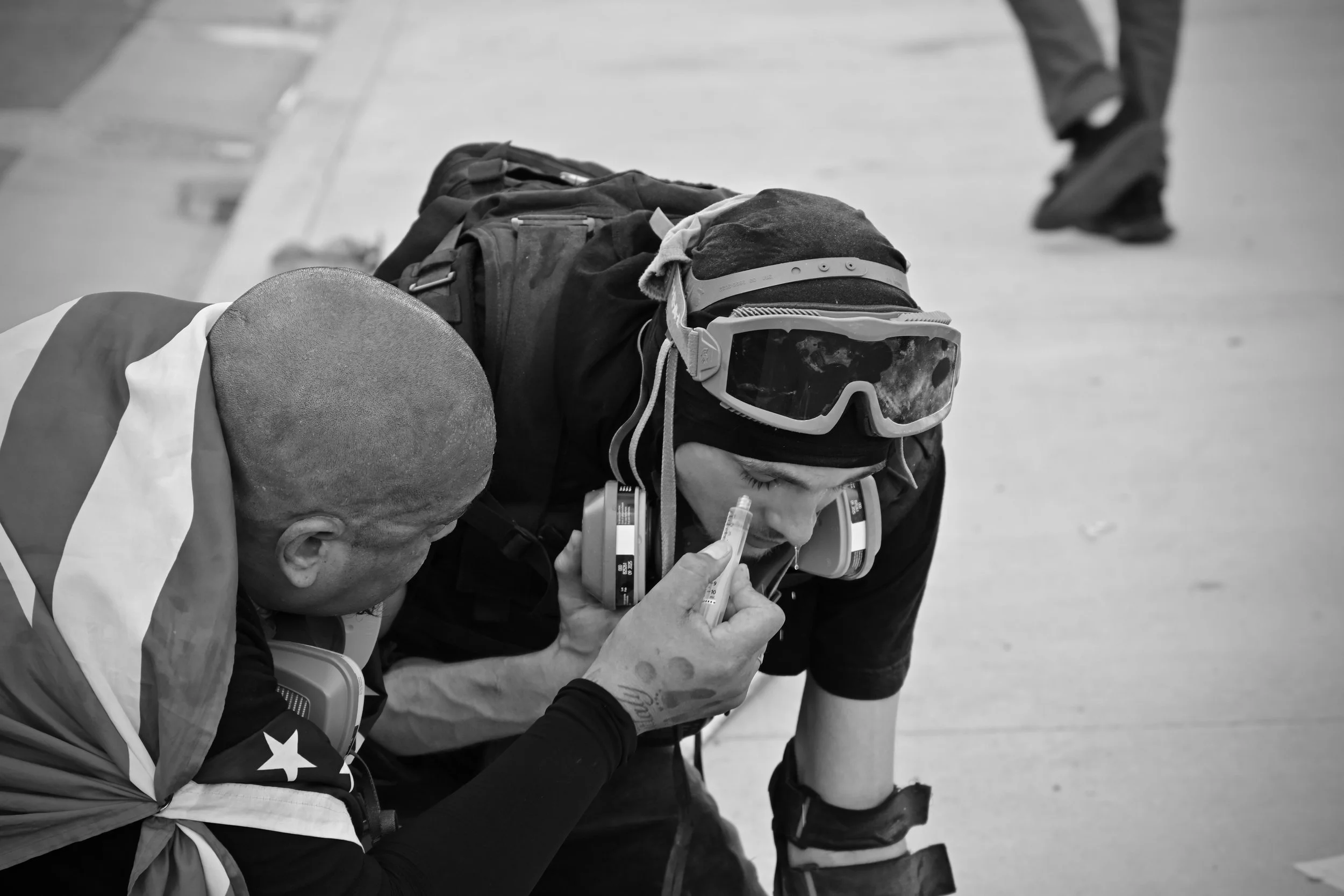 Protester being treated for CS gas induced pain to the eyes, nose, mouth and lungs. (Los Angeles, 2026) 