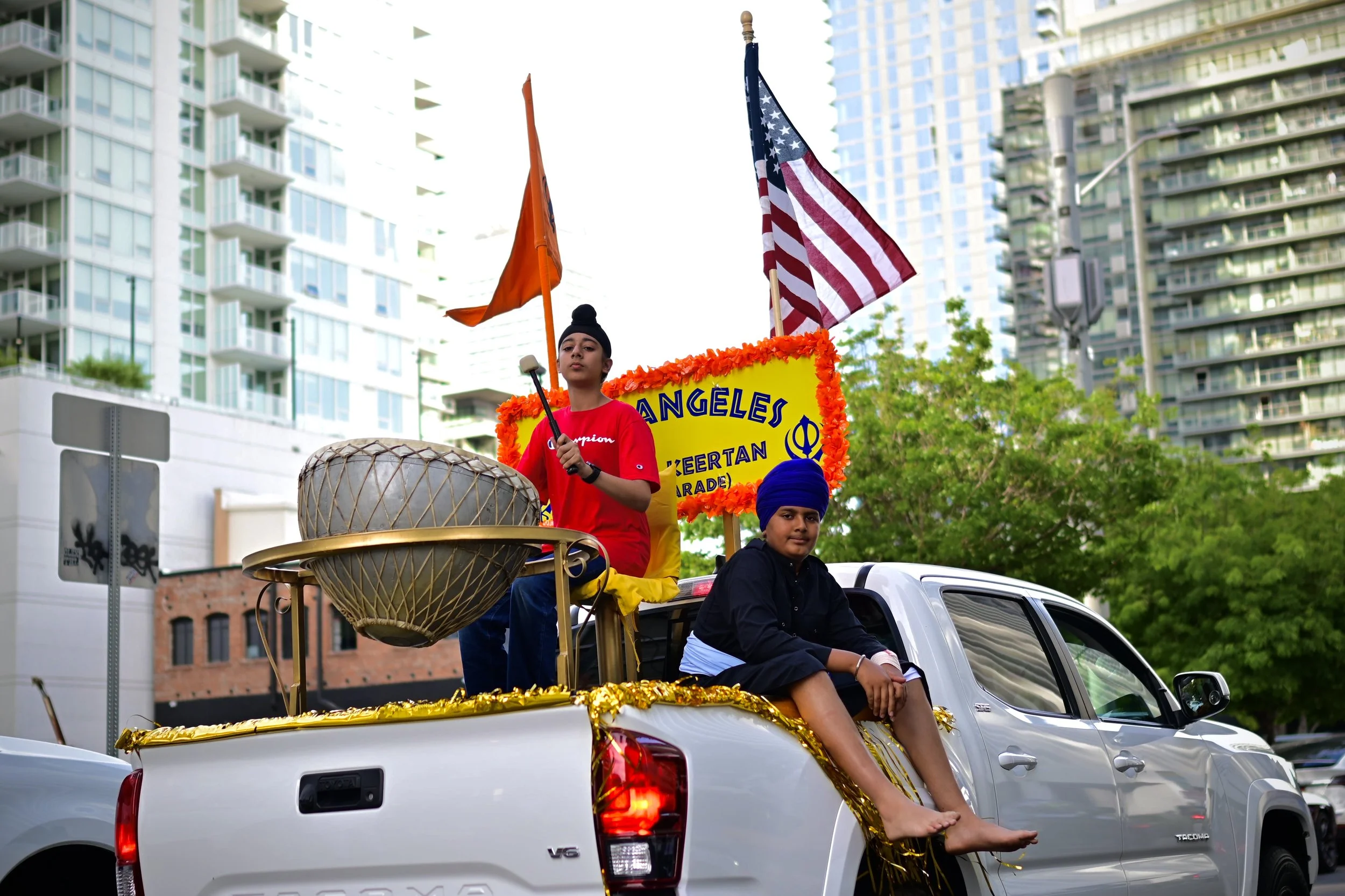 Two Sikhs on back of truck playing music leading the festival. (Los Angeles, 2026) 