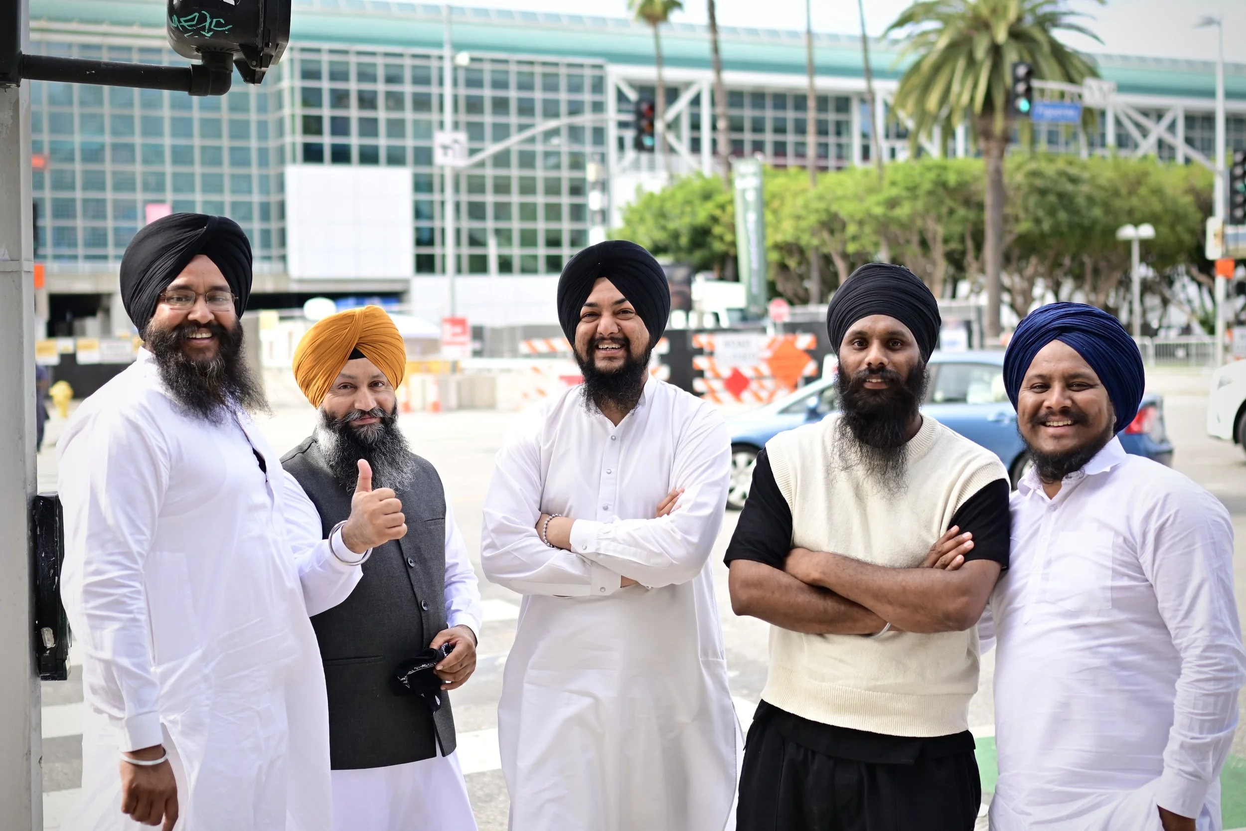 A group of Sikhs I photographed walking towards the celebration. The man second from the right, pointed to my camera and grabbed his friends for a picture. (Los Angeles, 2026)