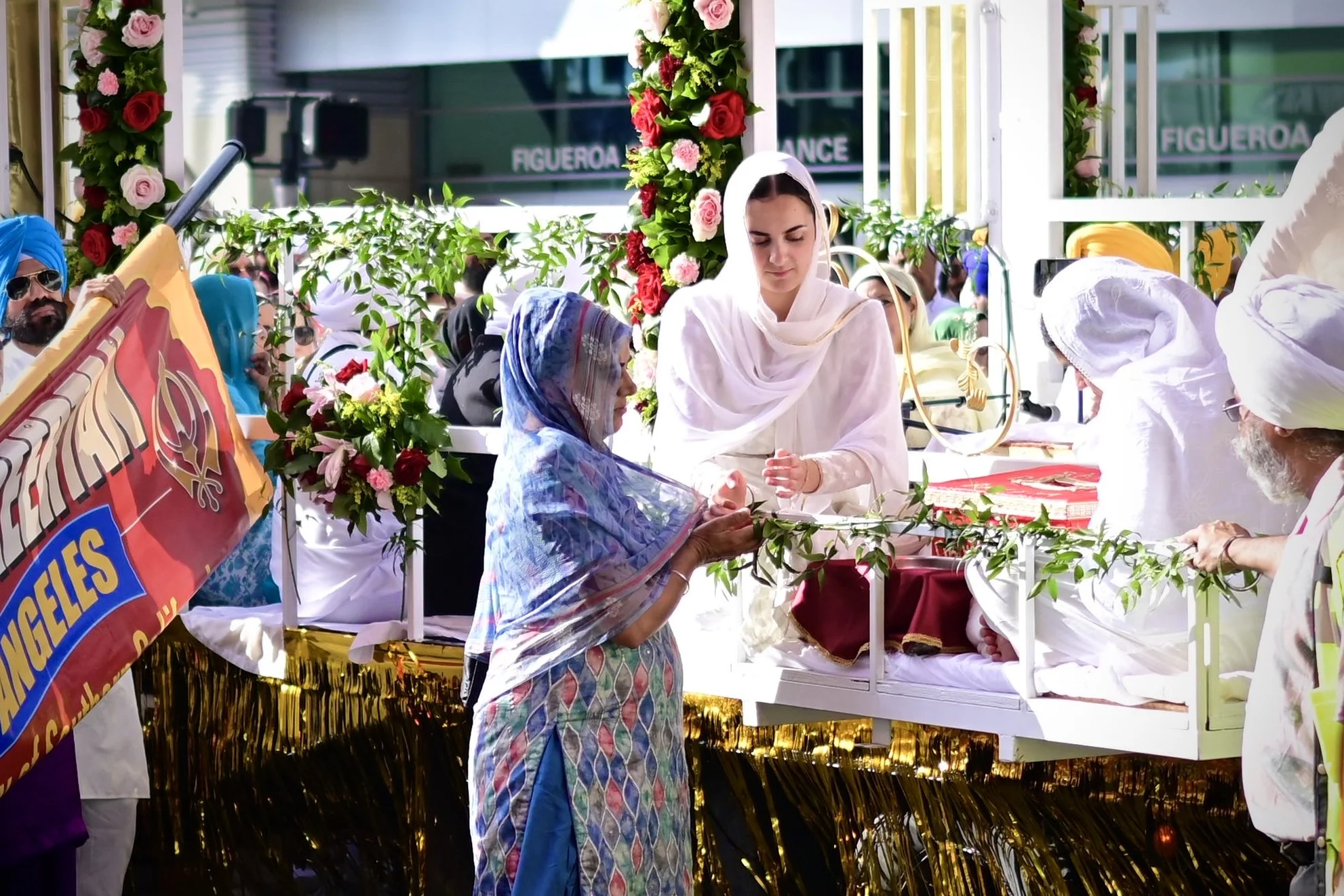 Sevadars on the float passing out sweets which are seen as blessing. Sevadars are individuals who perform selfless service (seva) out of love for the community. (Los Angeles, 2026)