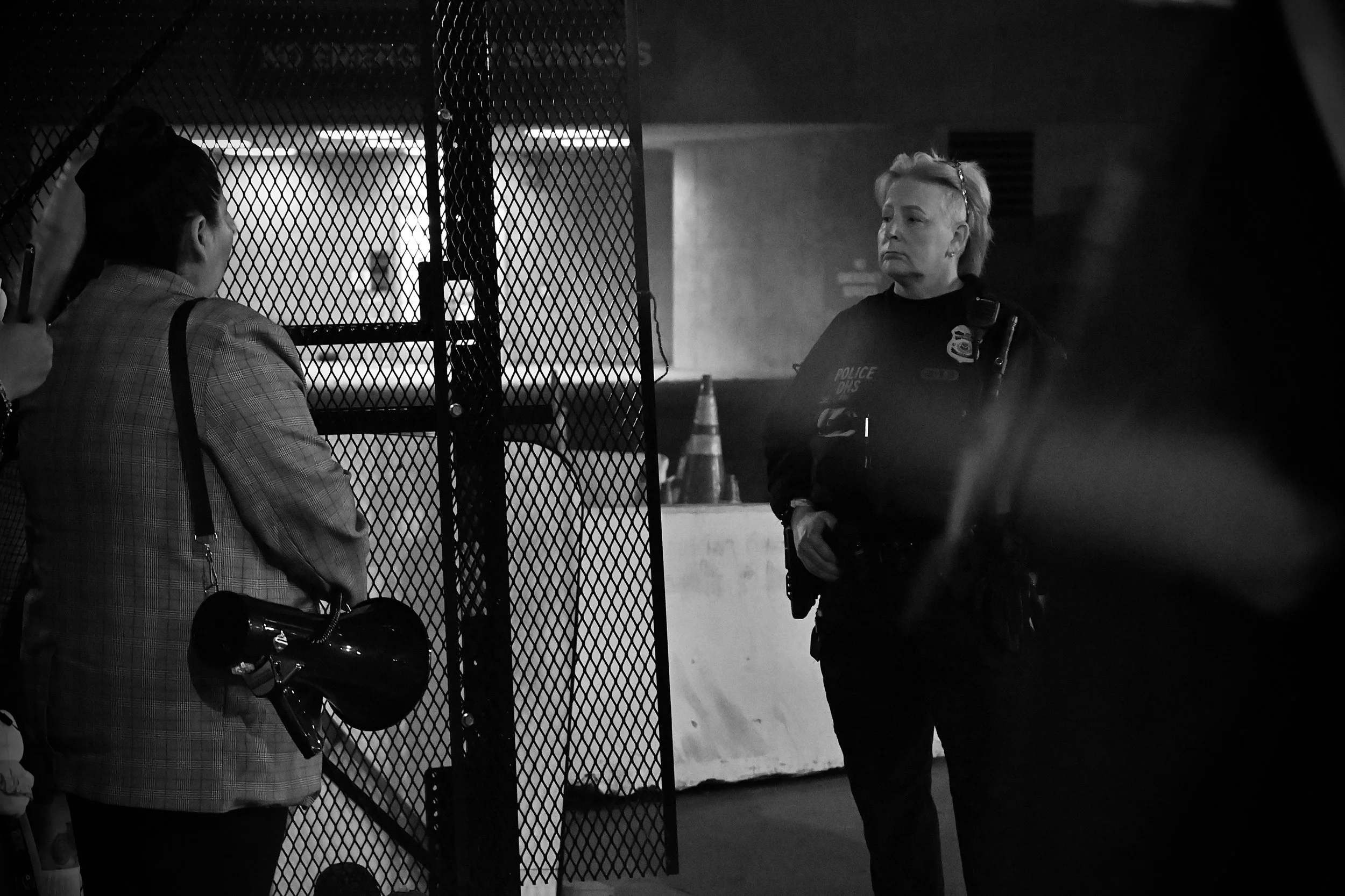A DHS agent engages in a heated conversation with protesters. (Los Angeles, 2025)