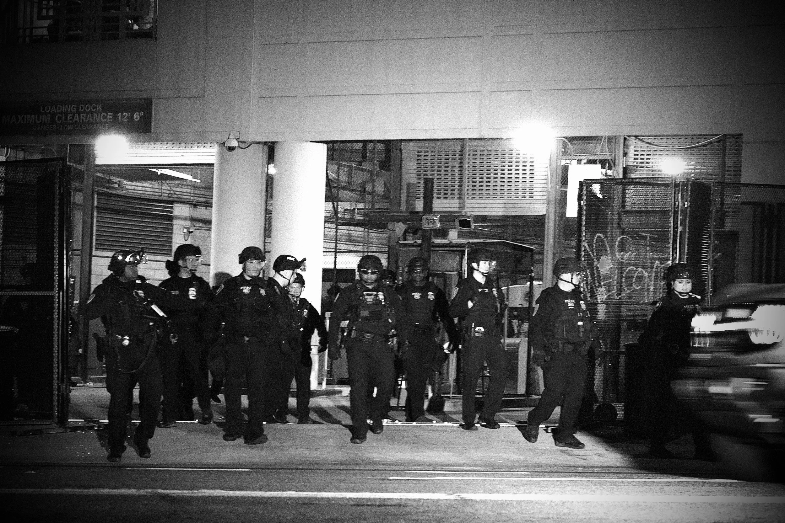 A group of DHS agents position themselves in front of the Detention Center, creating a barrier between the facility and the protesters. (Los Angeles, 2025)