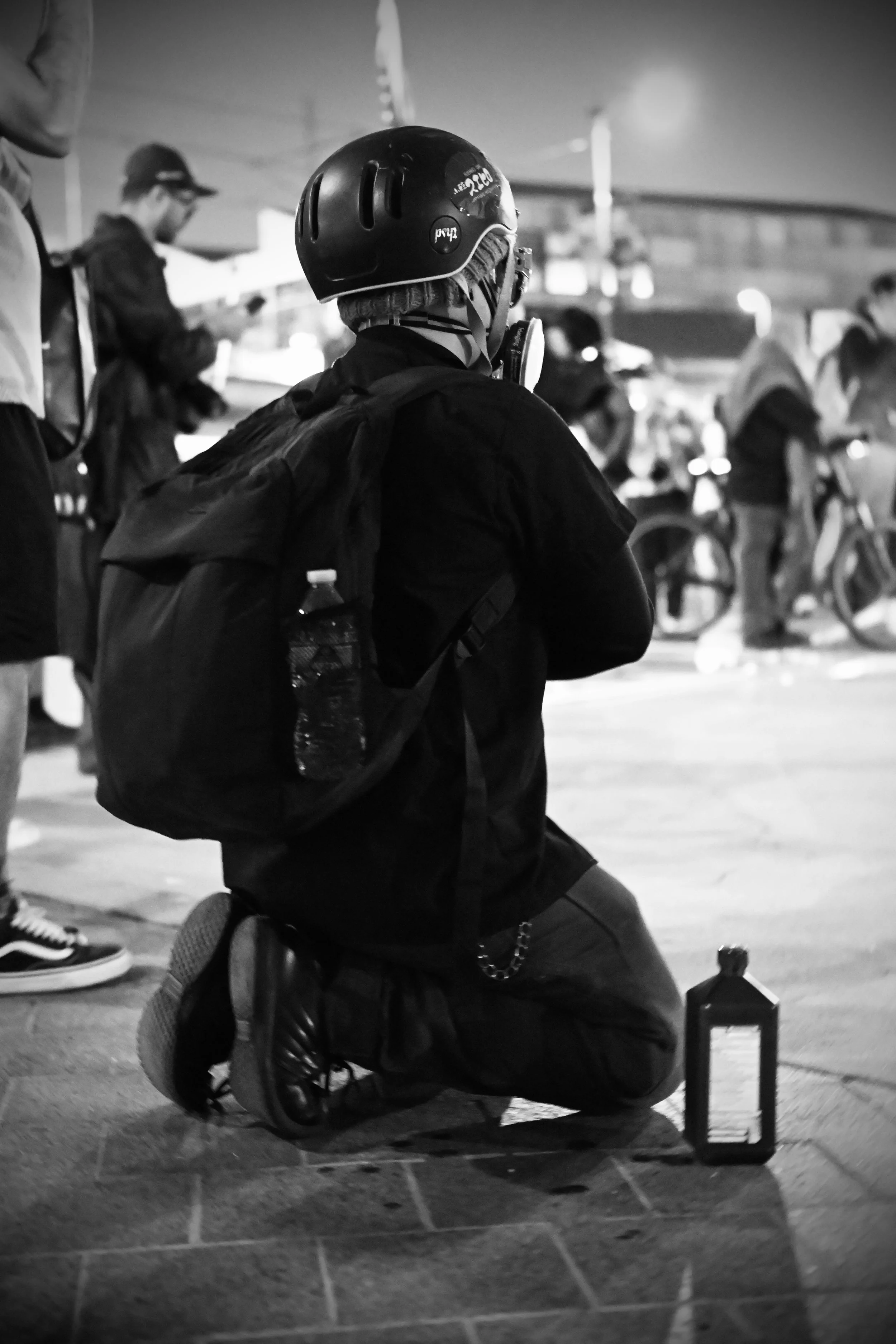 As DHS and ICE’s SRT move to engage the crowd, a protester in medical gear prepares supplies, assembling solutions to flush pepper spray from eyes and readying bandages and hydrogen peroxide for injuries. (Los Angeles, 2026)